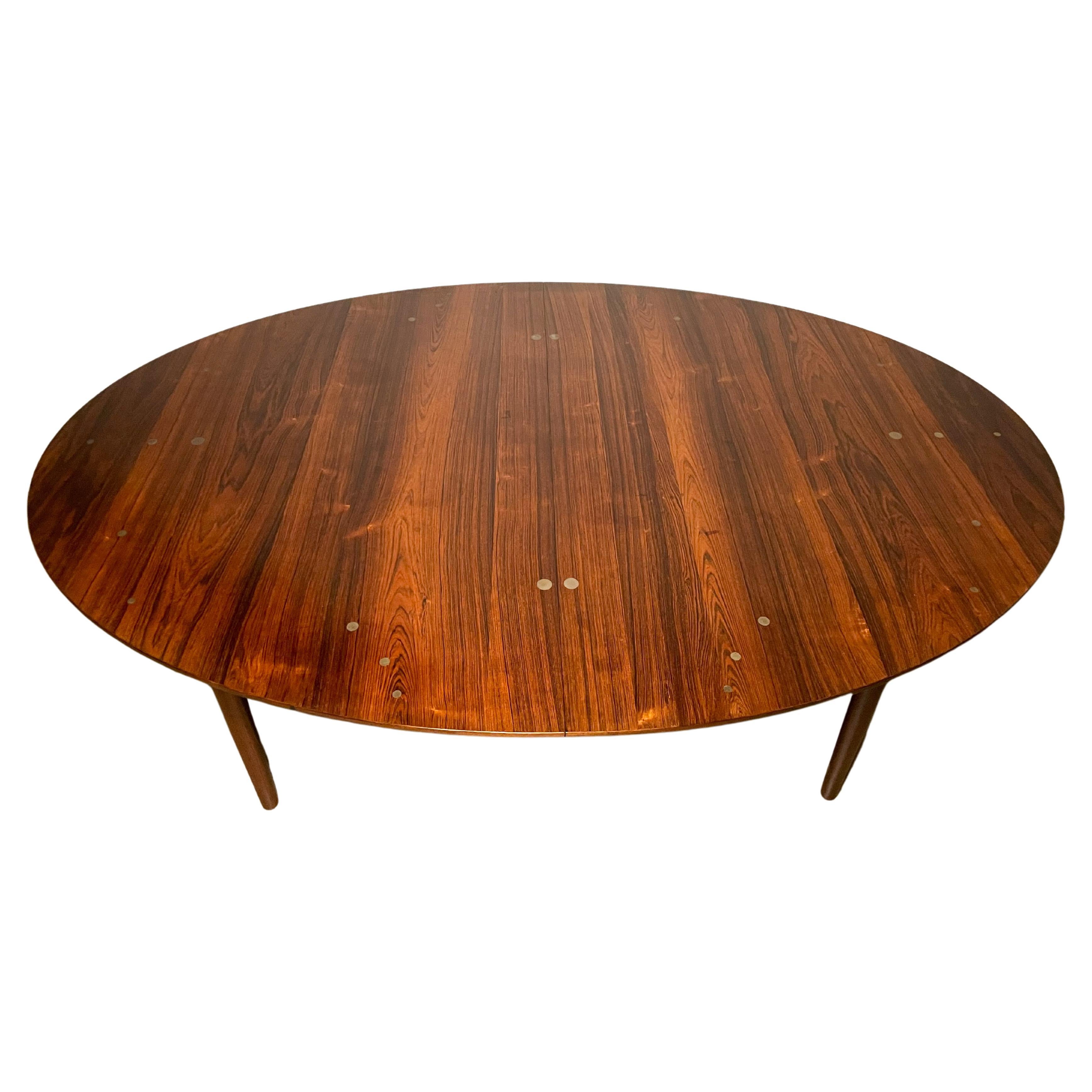 Breathtakingly beautiful Brazilian Rosewood dining table with Silver inlay designed by Finn Juhl and made by master cabinetmaker Niels Vodder. Highly collectible and perhaps the pinnacle of Danish Modern dining table design.

The table is 78