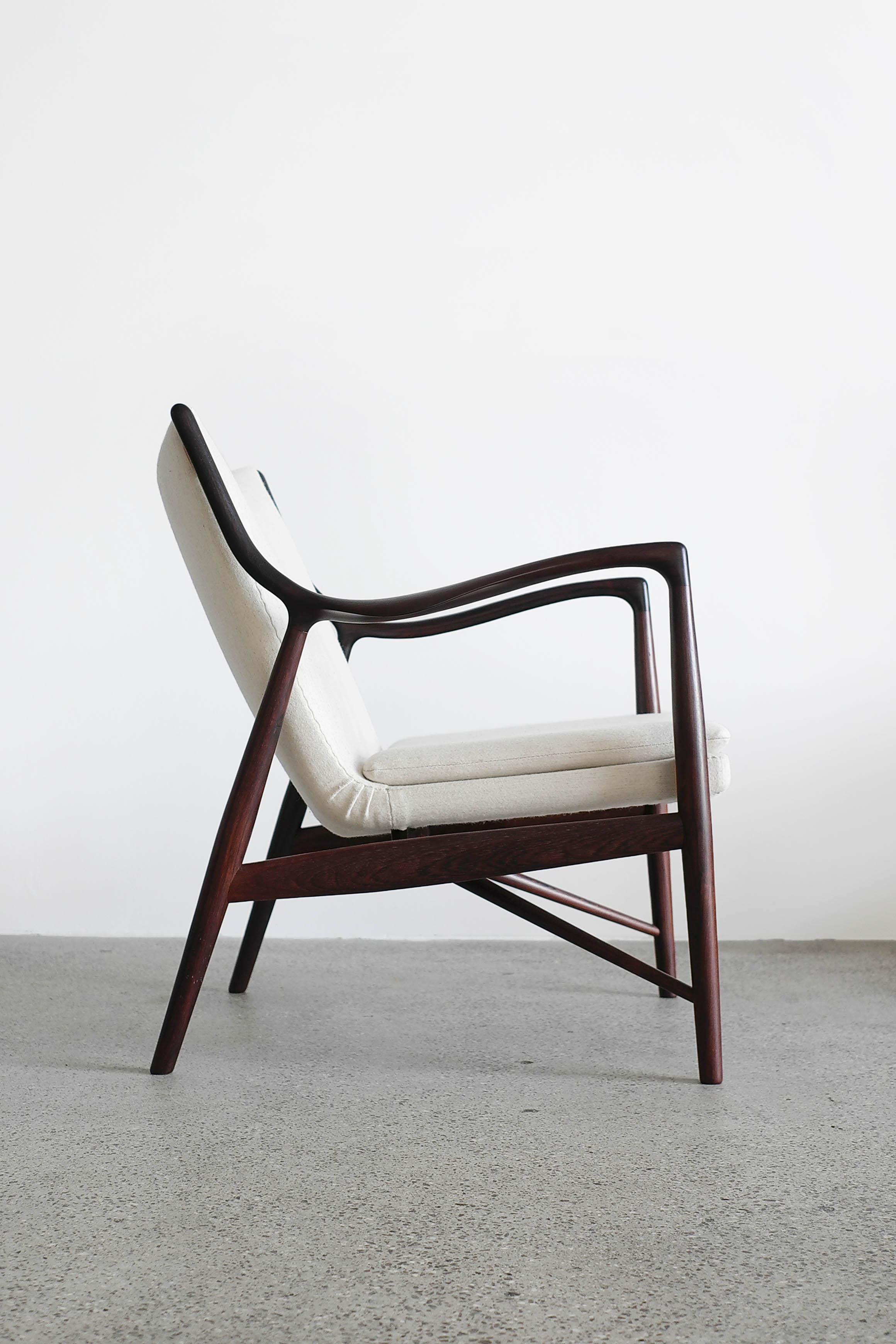 Finn Juhl NV 45 chair with frame of Brazilian rosewood, upholstered with fabric.

Designed 1945 and made at cabinetmaker Niels Vodder. Stamped by maker. 

A pair of 45 chairs in rosewood available.