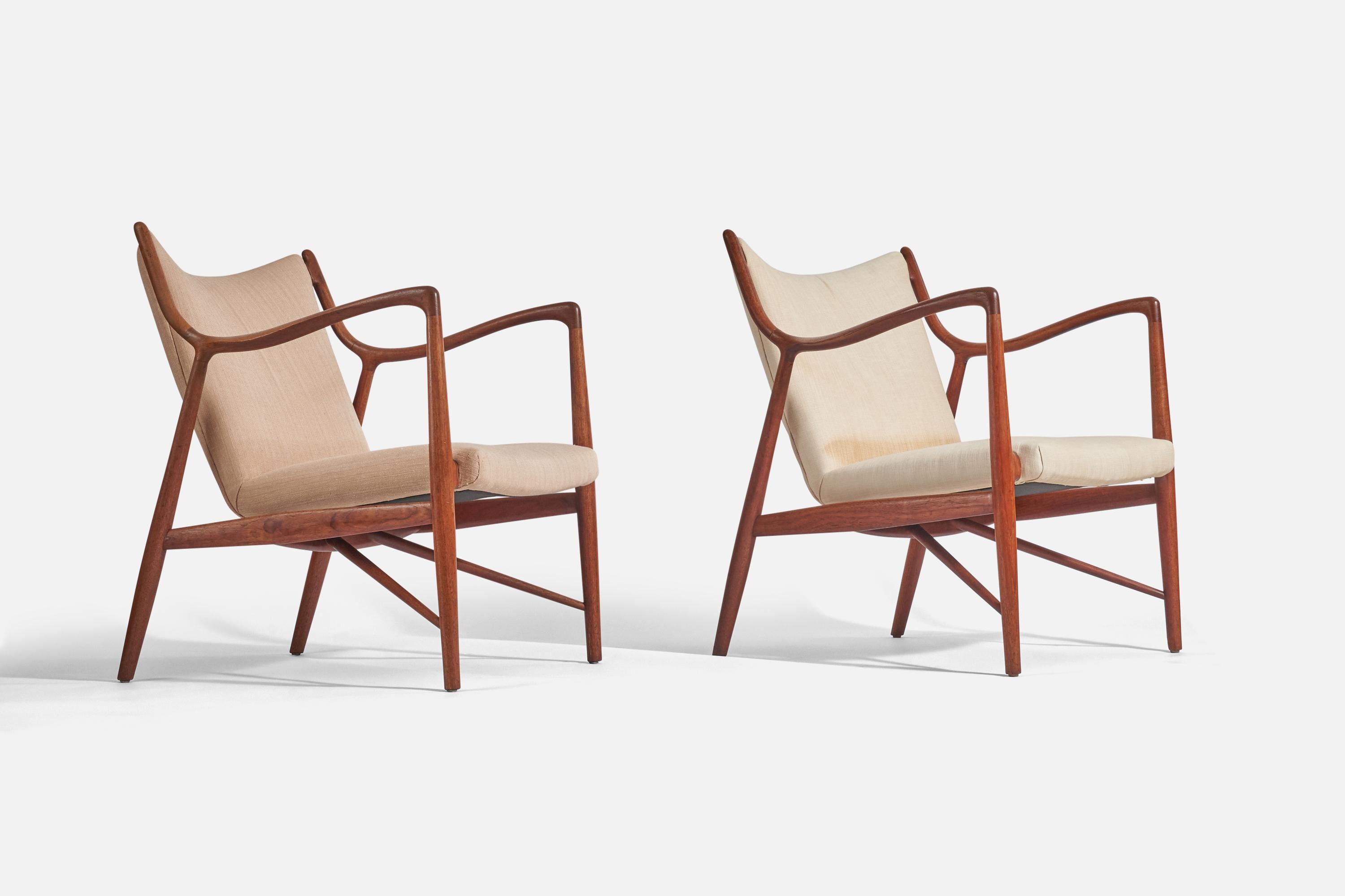 A pair of fabric and teak NV-45 lounge chairs designed by Finn Juhl and produced by Niels Vodder, Denmark, 1945. 