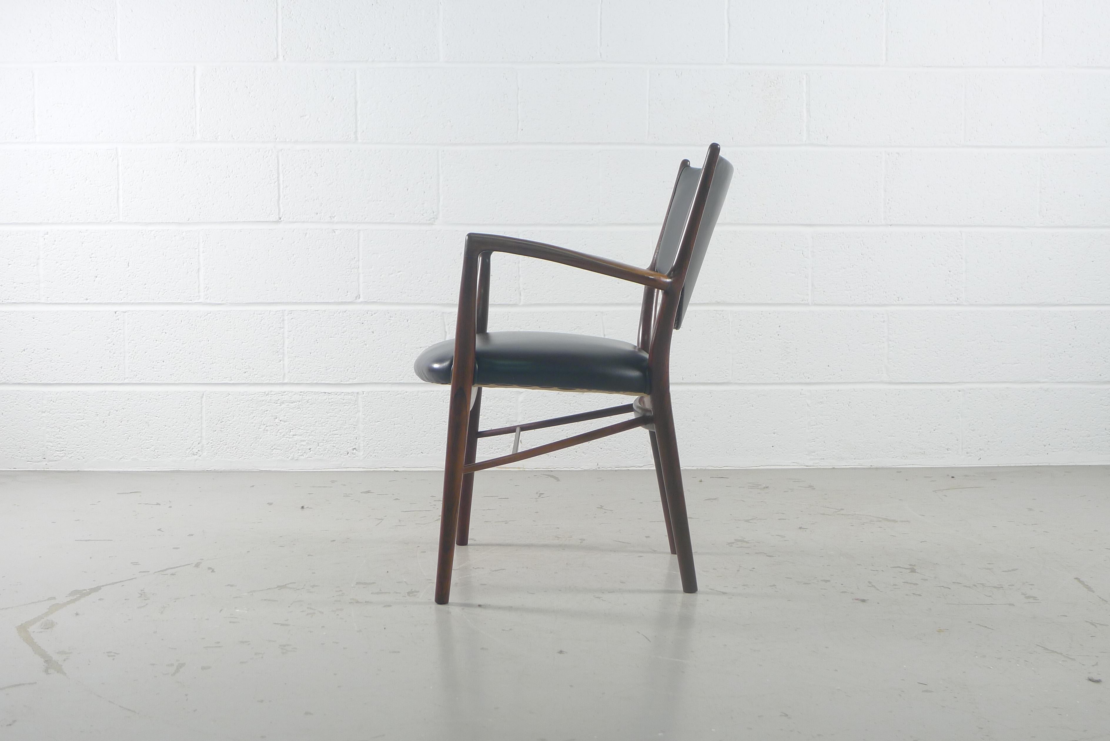 Finn Juhl NV-46 chair designed in 1946 for cabinetmaker Niels Vodder, Brazilian rosewood frame with black leather seat and back, elegant and lightweight in appearance.
Stamped behind front stretcher 
