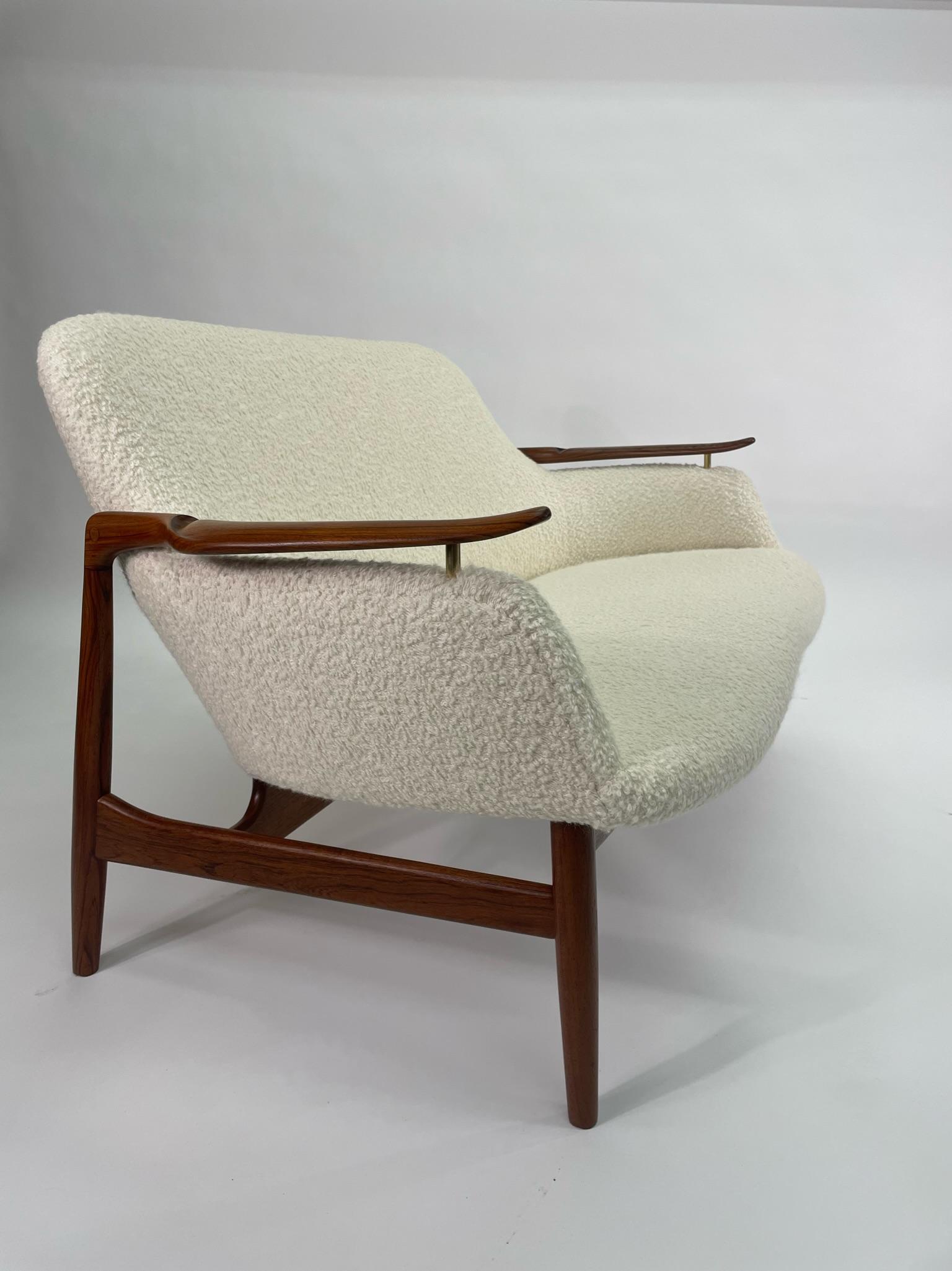 A rare example of the stunning, sculptural settee by Danish design pioneer Finn Juhl. The NV-53 is named after its cabinetmaker, Niels Vodder, and the year of its design, 1953. Its biomorphic shape—influenced by the Surrealists—and unique, floating