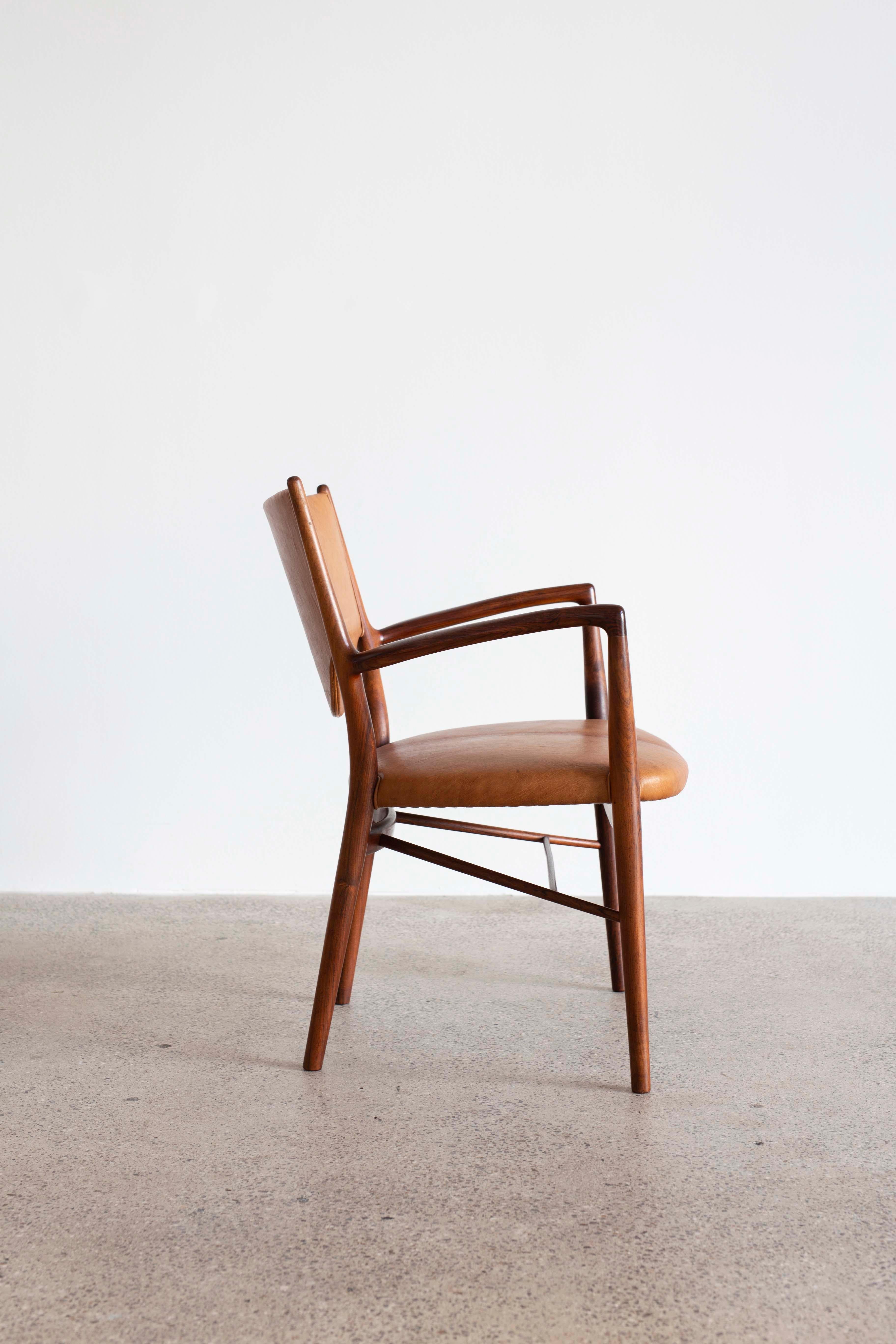Finn Juhl NV-46 armchair with frame of Brazilian rosewood, upholstered with Nigerian leather. 
Designed 1946, executed and burn marked by cabinetmaker Niels Vodder, Denmark. 

A pair available.
