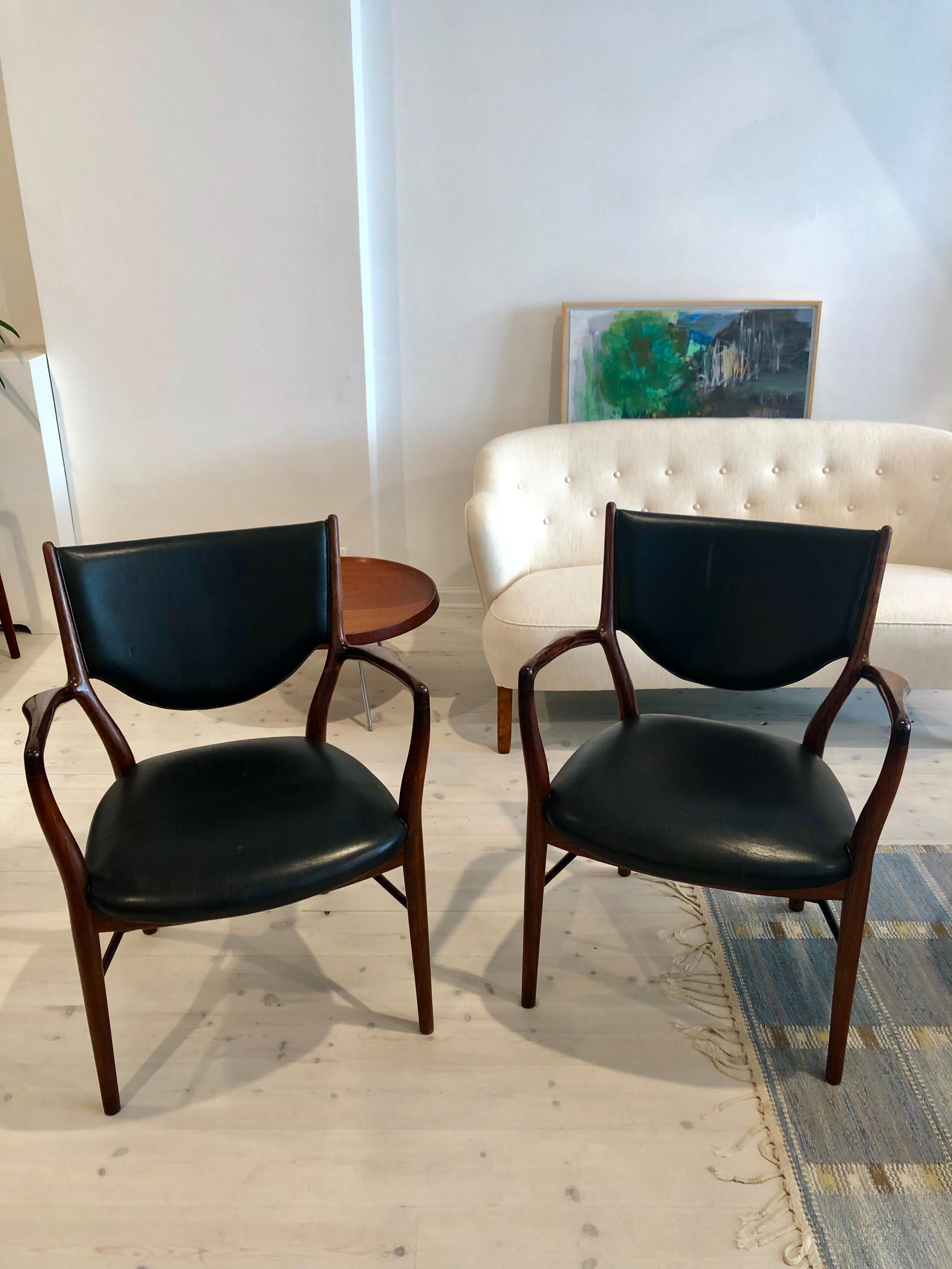 Finn Juhl, pair of NV46 armchairs in Brazilian rosewood and original black leather for master cabinetmaker Niels Vodder. Designed 1946.

Each chair branded manufacturer’s mark to underside: 'Cabinetmaker Niels Vodder, Copenhagen Denmark, Design