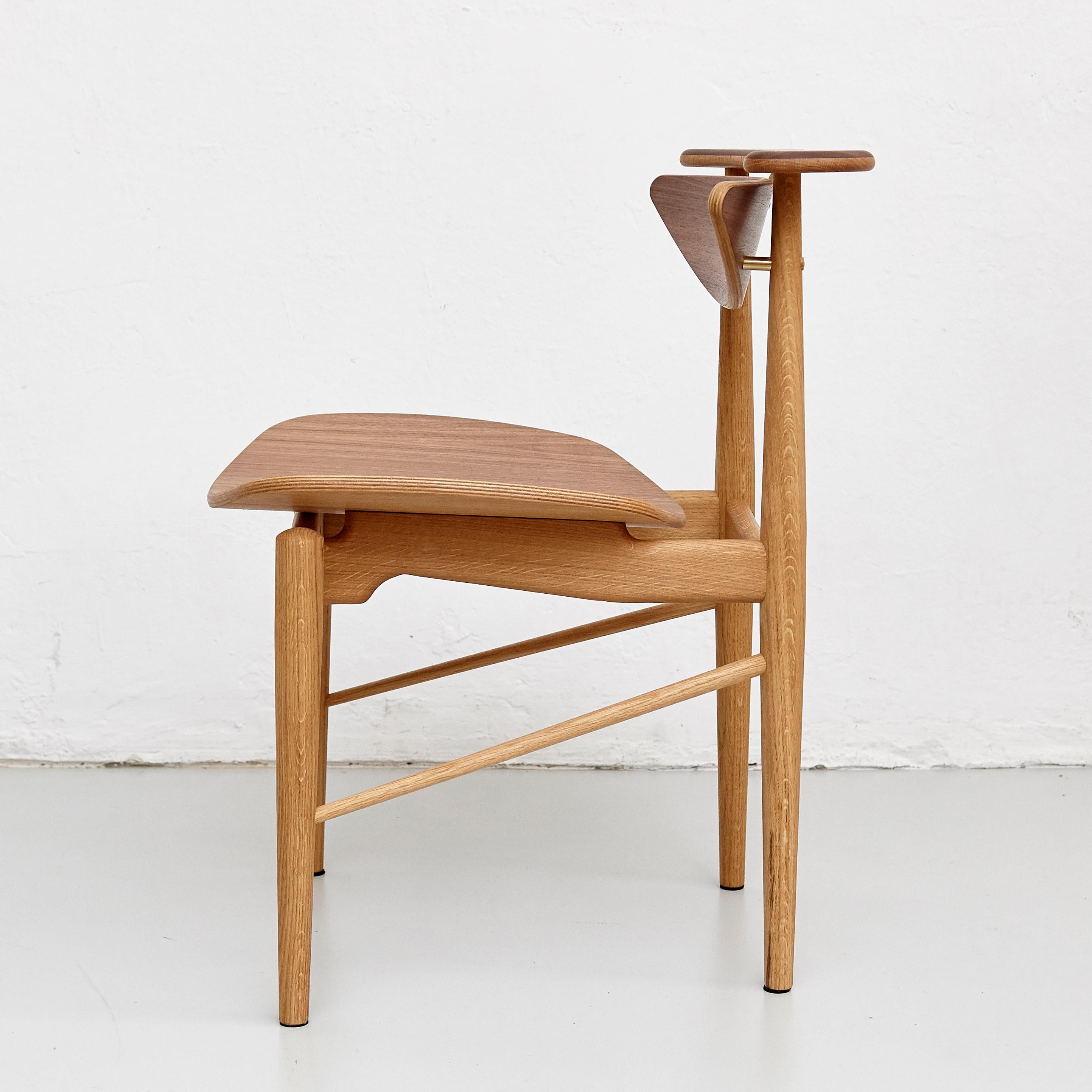 Chair designed by Finn Juhl in 1953, relaunched in 2015.
Manufactured by House of Finn Juhl in Denmark.

The Reading chair is one of Finn Juhl's more simple, yet elegant, pieces. The chair is characterized by intricate details and a quirky story.