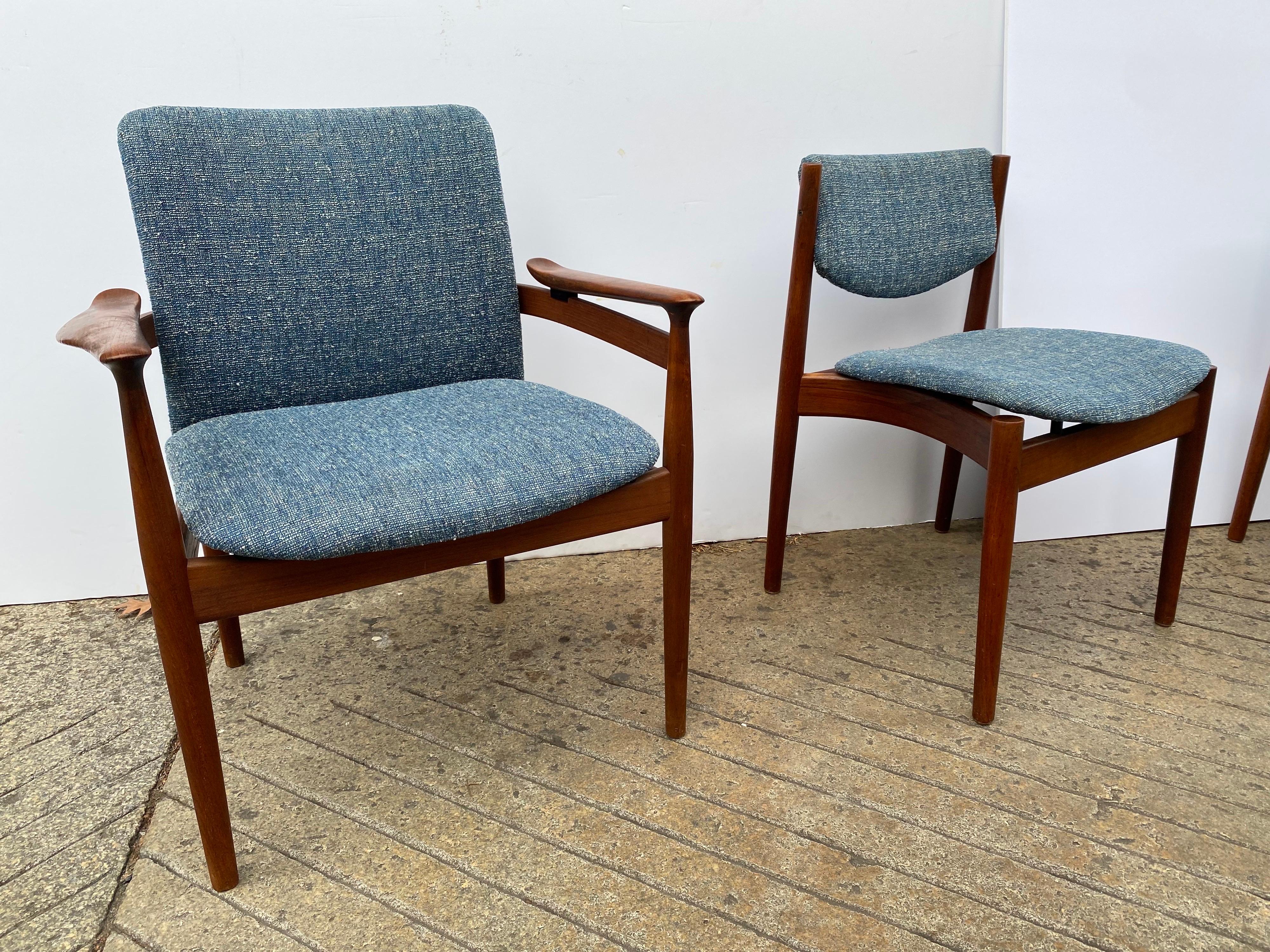 Set of 6 Finn Juhl Solid teak dining chairs, 2 arm and 4 armless floating chairs. Solid teak frames with seats and backs set slightly apart from wood frames to give a floating quality to the chairs. Beautifully made with attention given to every