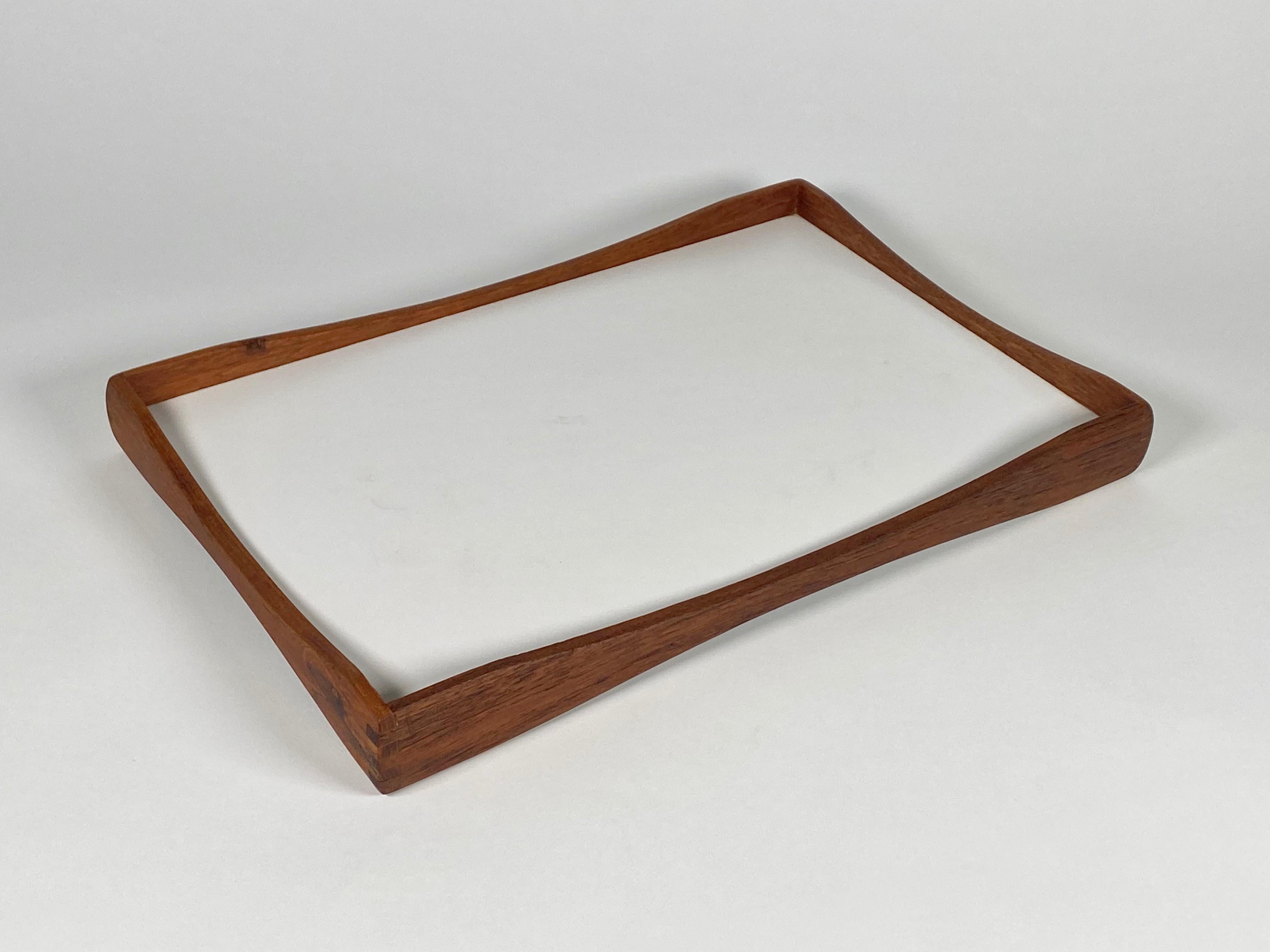 Double sided serving tray with black and white laminate surfaces on either side, the frame is constructed of  teak with gently raised ends starting in the middle and finishing with interlocking joinery. Rich color to the teak with hints of black in