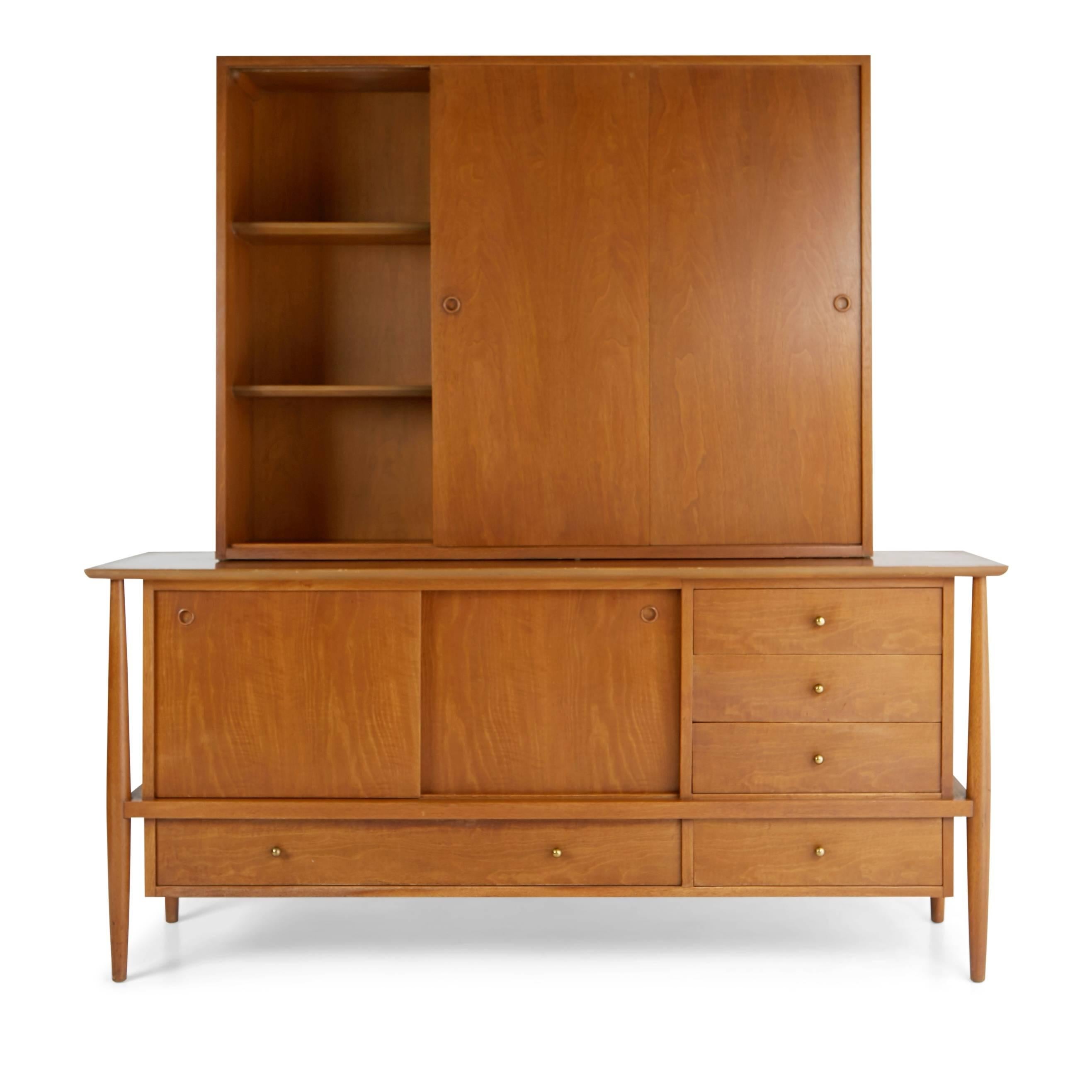 Mid-Century Modern two-piece display hutch and buffet in the style of Finn Juhl and Edmond Spence. Fabricated from walnut this grand scaled piece provides plenty of storage. The display cabinet has a central sliding glass panel flanked by sliding