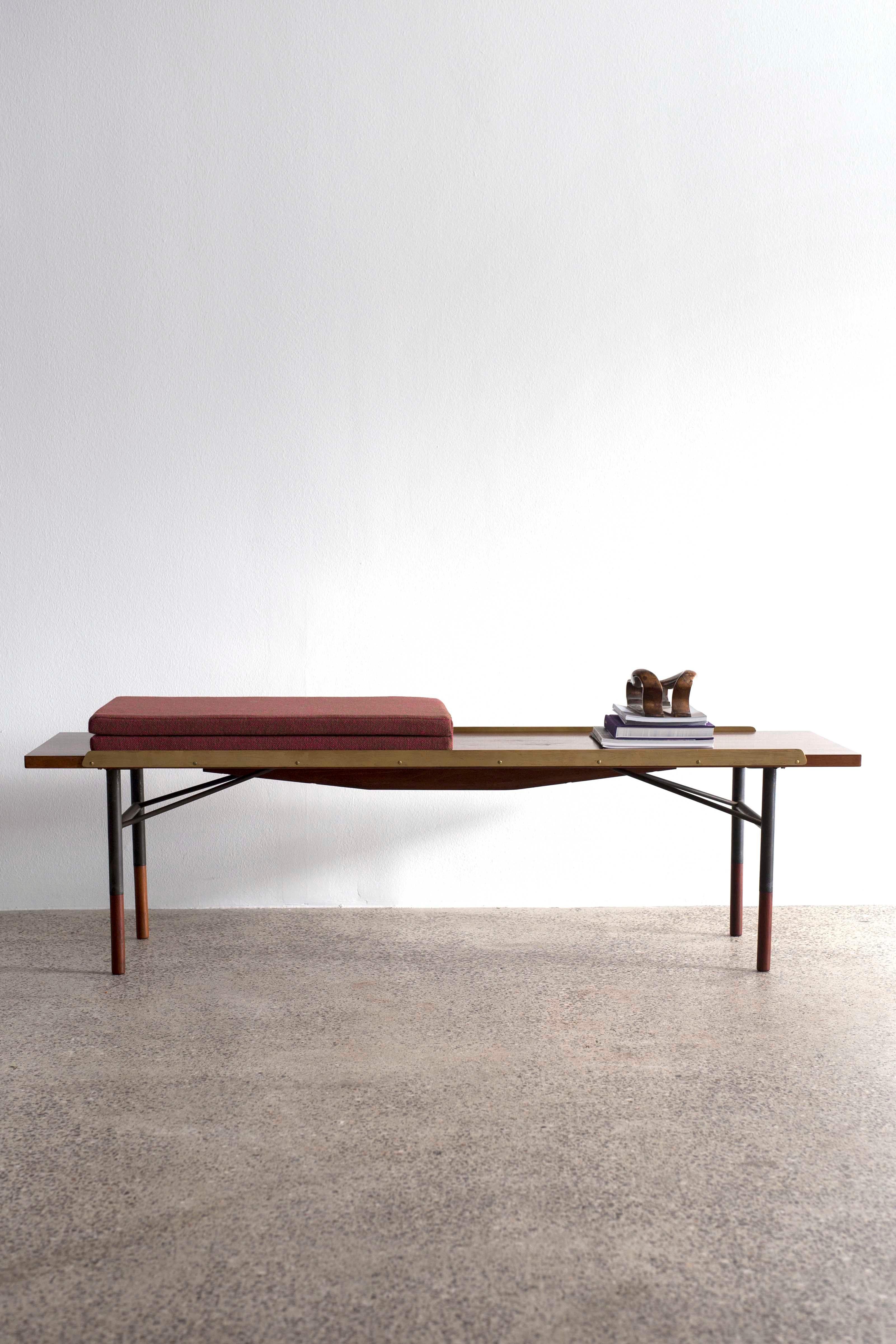 Finn Juhl table bench in teak with foldable fabric cushion. 
Frame of gunmetal and brass lists. 
Designed 1953 and made at Bovirke, Denmark.