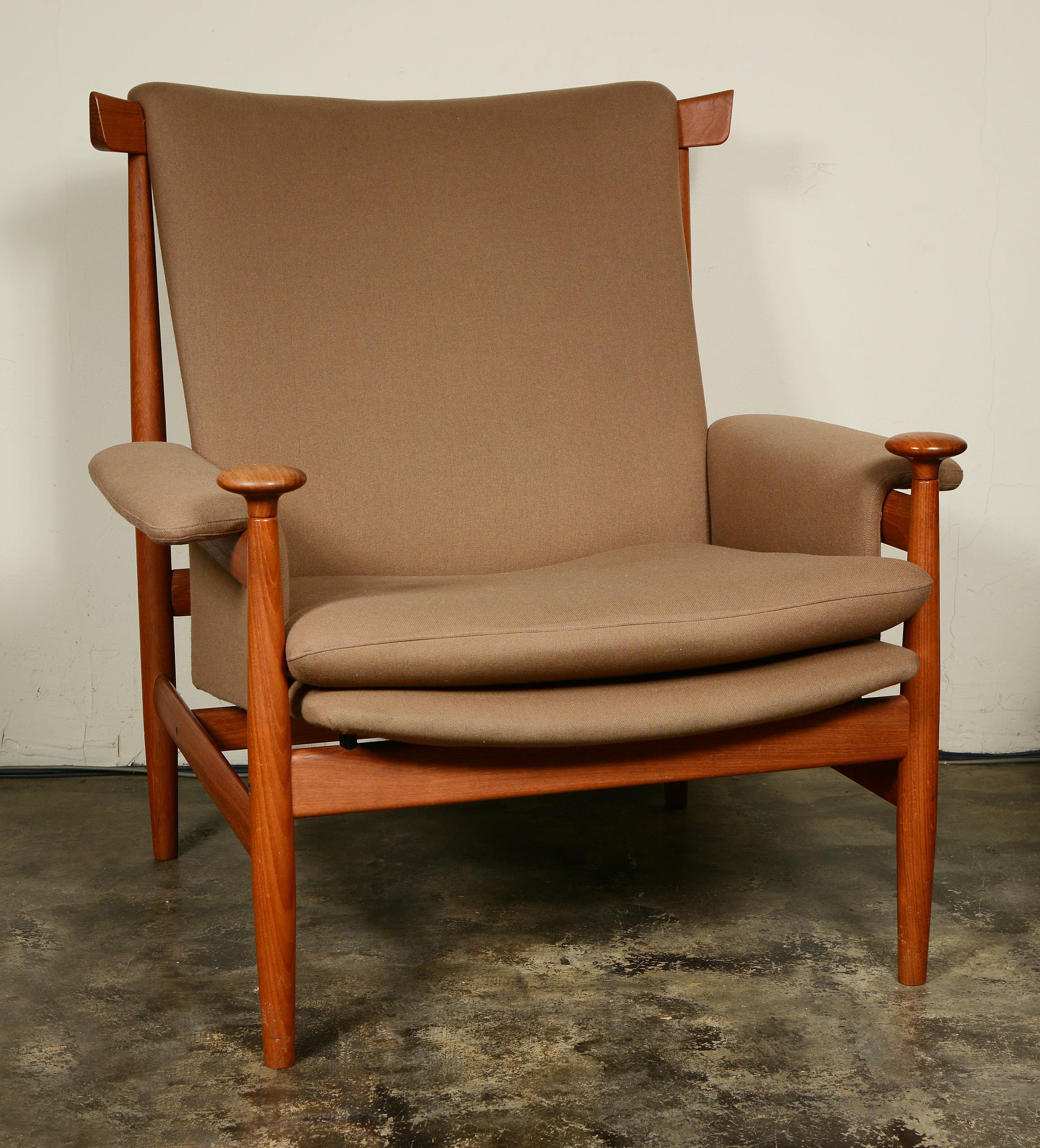 Bwana lounge chair designed by Finn Juhl for France and Son. The chair has a curved top back rail with finger joints attaching the rail parts. The front legs terminate with sculpted hand rests. The chair has both the France and Son and John Stewart