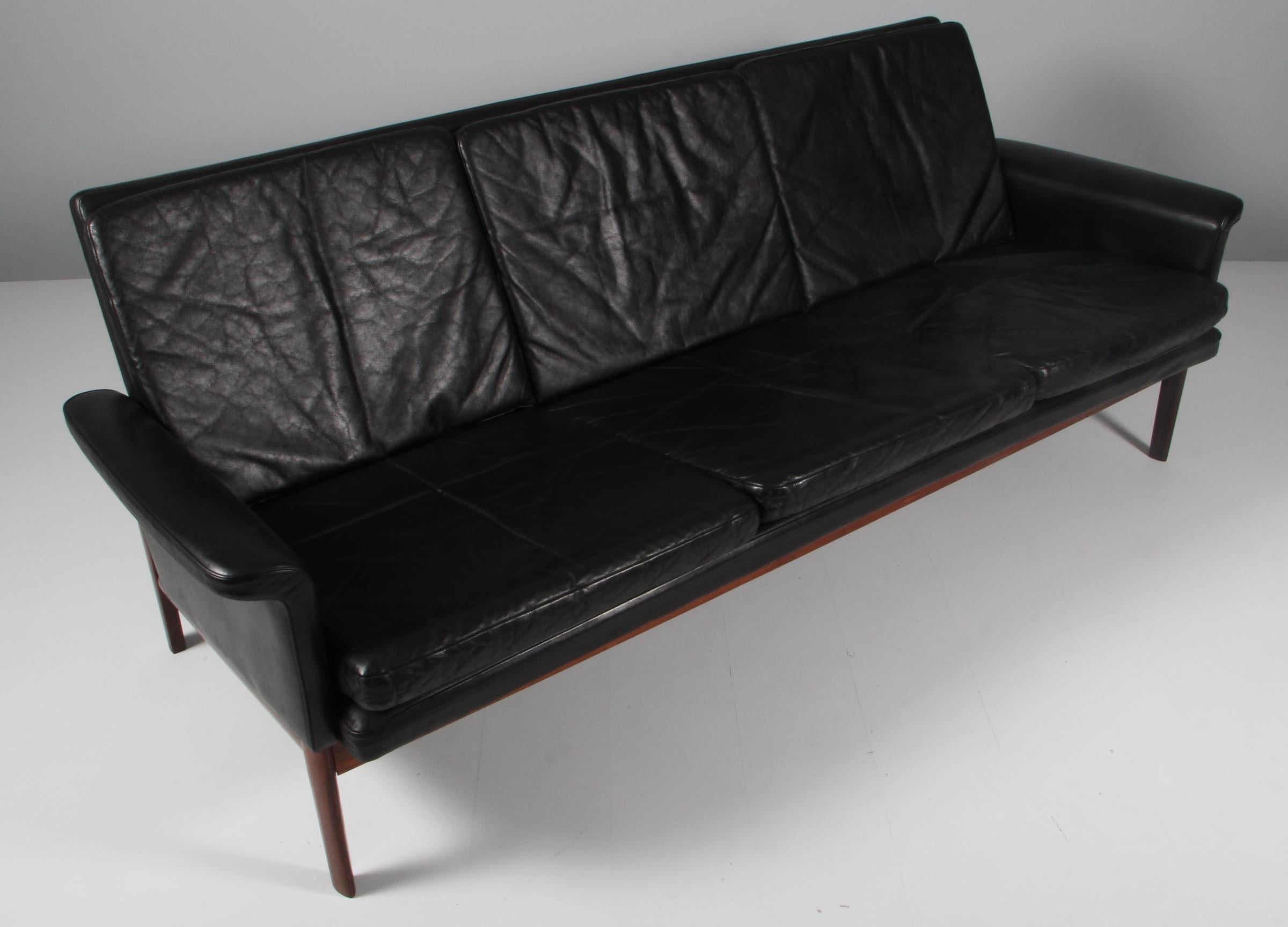 Finn Juhl three seat sofa with original black leather upholstery with a wonderful patina. 

Frame of solid rosewood, with great details.

Model 218/3 from the Jupiter Series, made by France & Daverkosen.