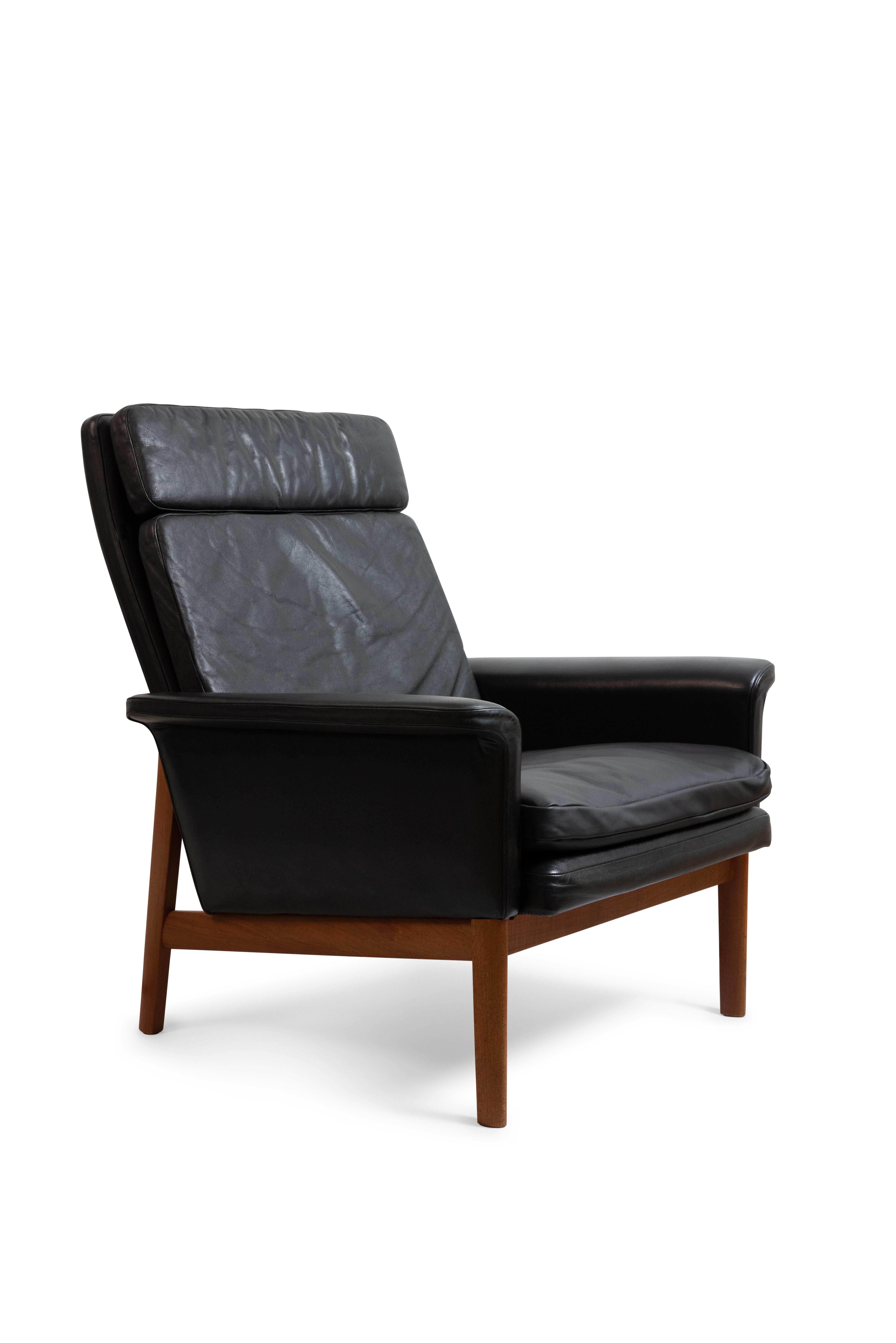Finn Juhl lounge highback chair with original black leather upholstery with a wonderful patina. 

Frame of solid teak.

Model 218 from the Jupiter Series, made by France & Daverkosen.