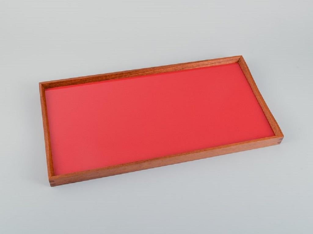 Finn Juhl, Turning Tray by Architectmade.
Teak tray with black/red laminate.
Designed by Finn Juhl in 1956.
2000s.
In perfect condition.
Measurements: L 45 x W 23 H 2.5.