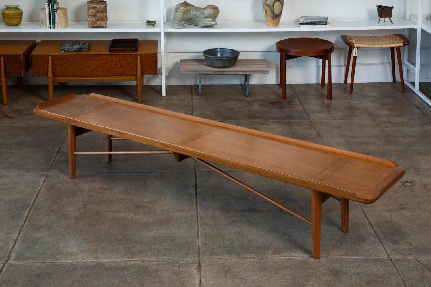 Finn Juhl designed this walnut bench for Baker in 1951, who then subsequently named it “Rectangular Cocktail Table”, even though Juhl’s original sketch was entitled “bench.”

The legs, seat, and stretchers are made of solid walnut and the top