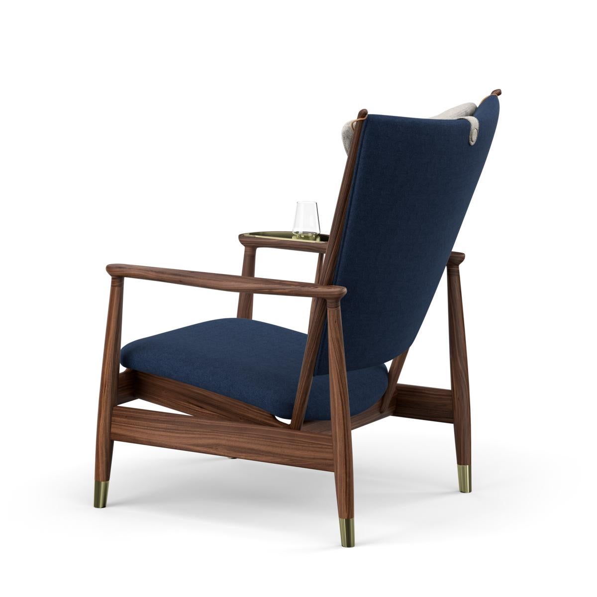 The Whisky chair was designed by Finn Juhl in 1948 and is characterized by his artistic sense of shape, function, and detail. 

The chair is produced in American walnut and is upholstered by hand in leather and/or textile. Furthermore, the chair is