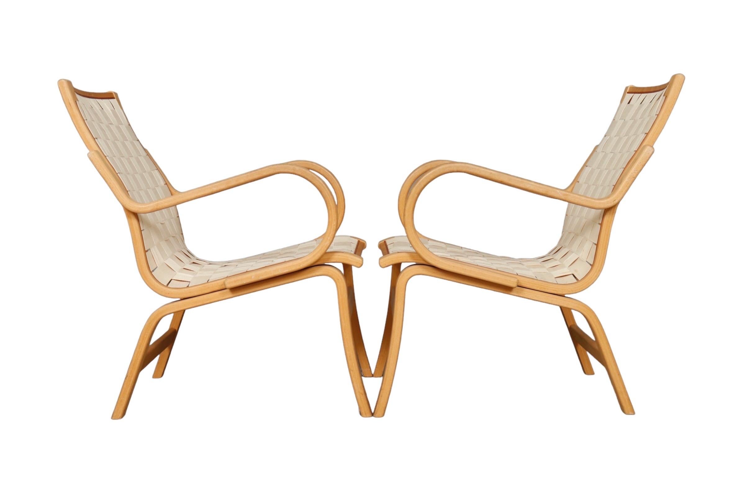A pair of Finn Østergaard “Albert” for Kvist lounge chairs. Bentwood frames are beech with canvas webbing and leather trim.