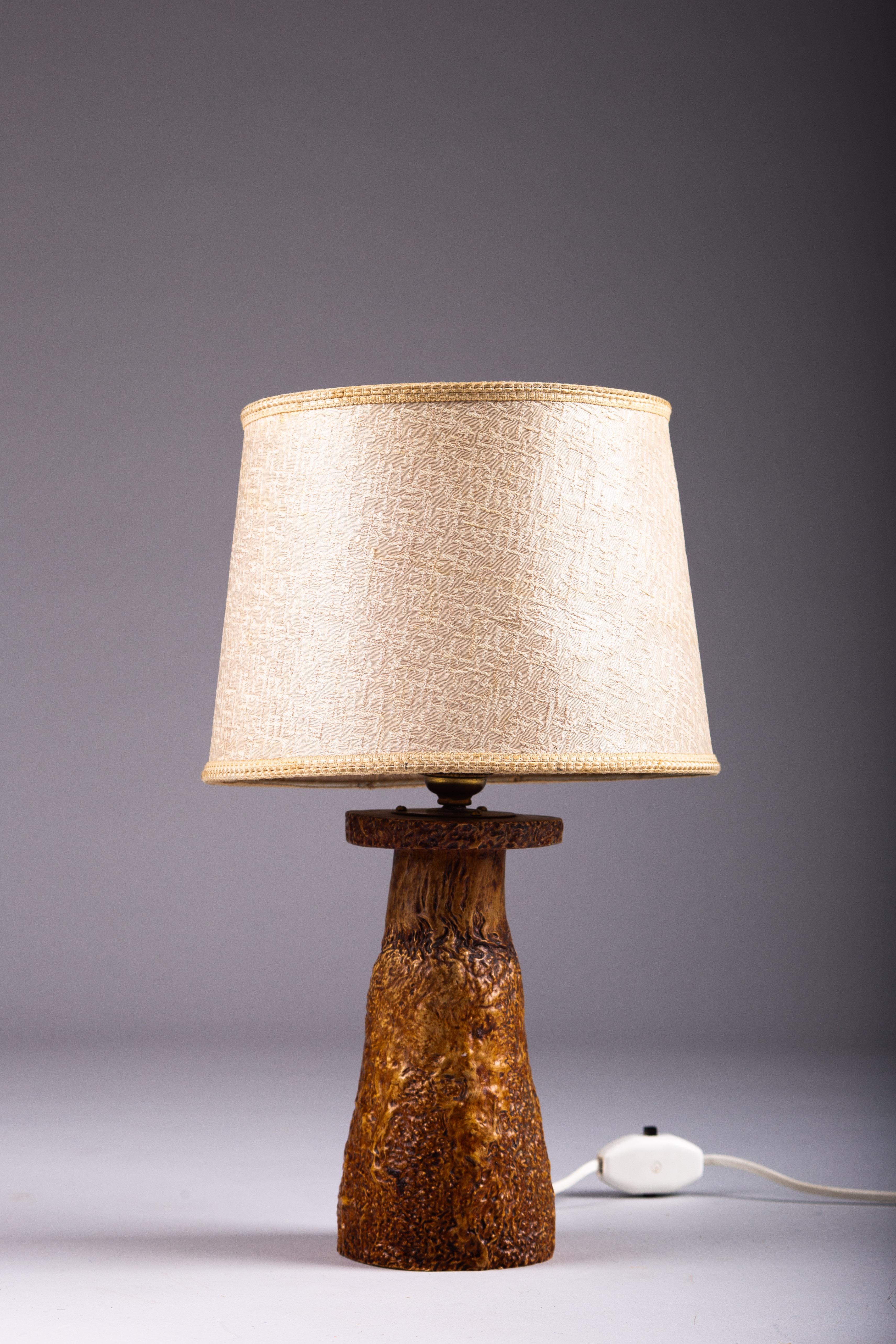 Discover timeless elegance with our Finnish 1930's curly birch table lamp. This exquisite piece is meticulously handcrafted from curly birch, showcasing the natural beauty and unique grain patterns that are hallmarks of Scandinavian design. Perfect