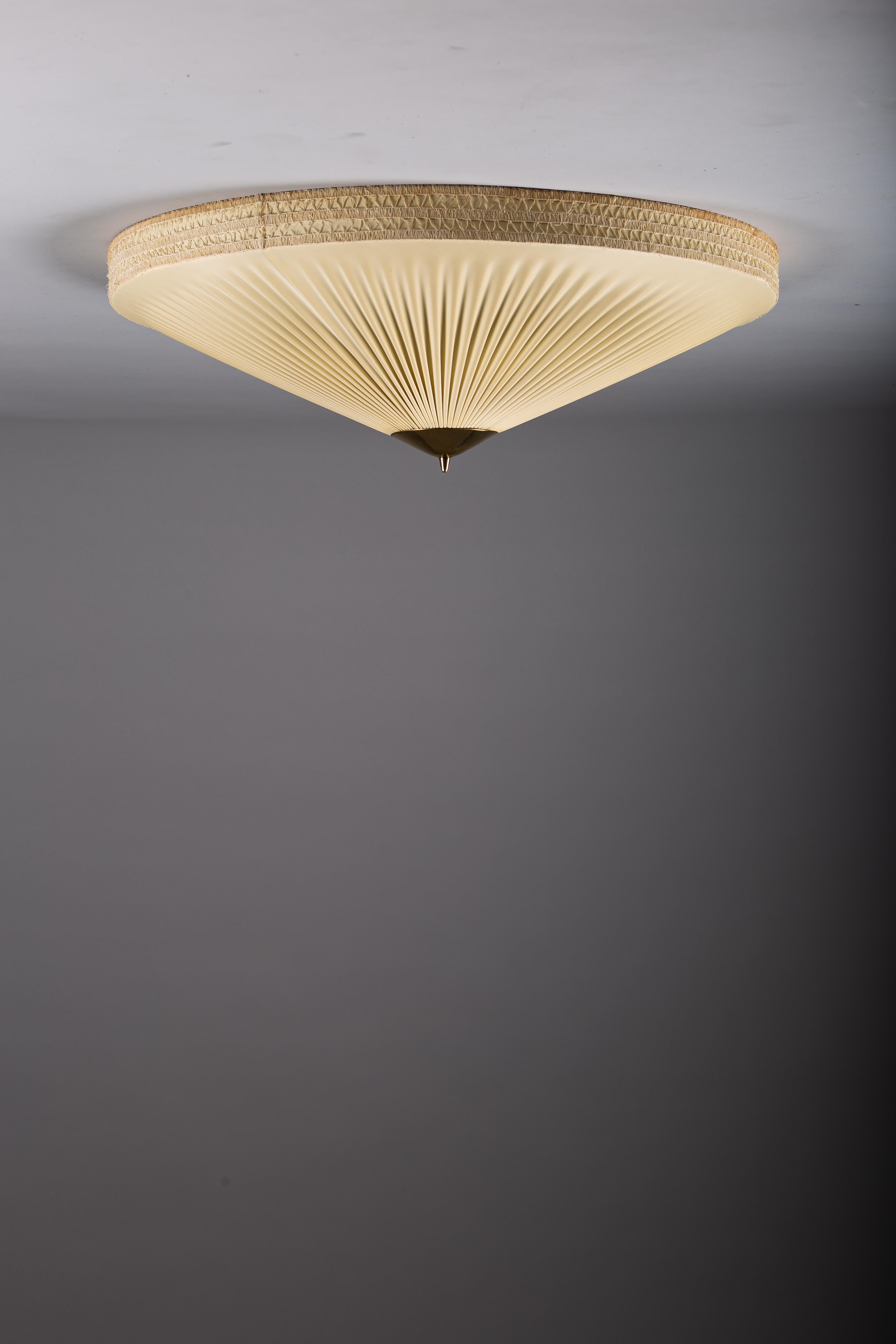 Illuminate your home with the distinguished allure of the 1950's Finnish big plafond lamp, measuring 70 cm in diameter. This classic fixture features refined brass details and an H label, confirming its vintage provenance. We recognize the value of