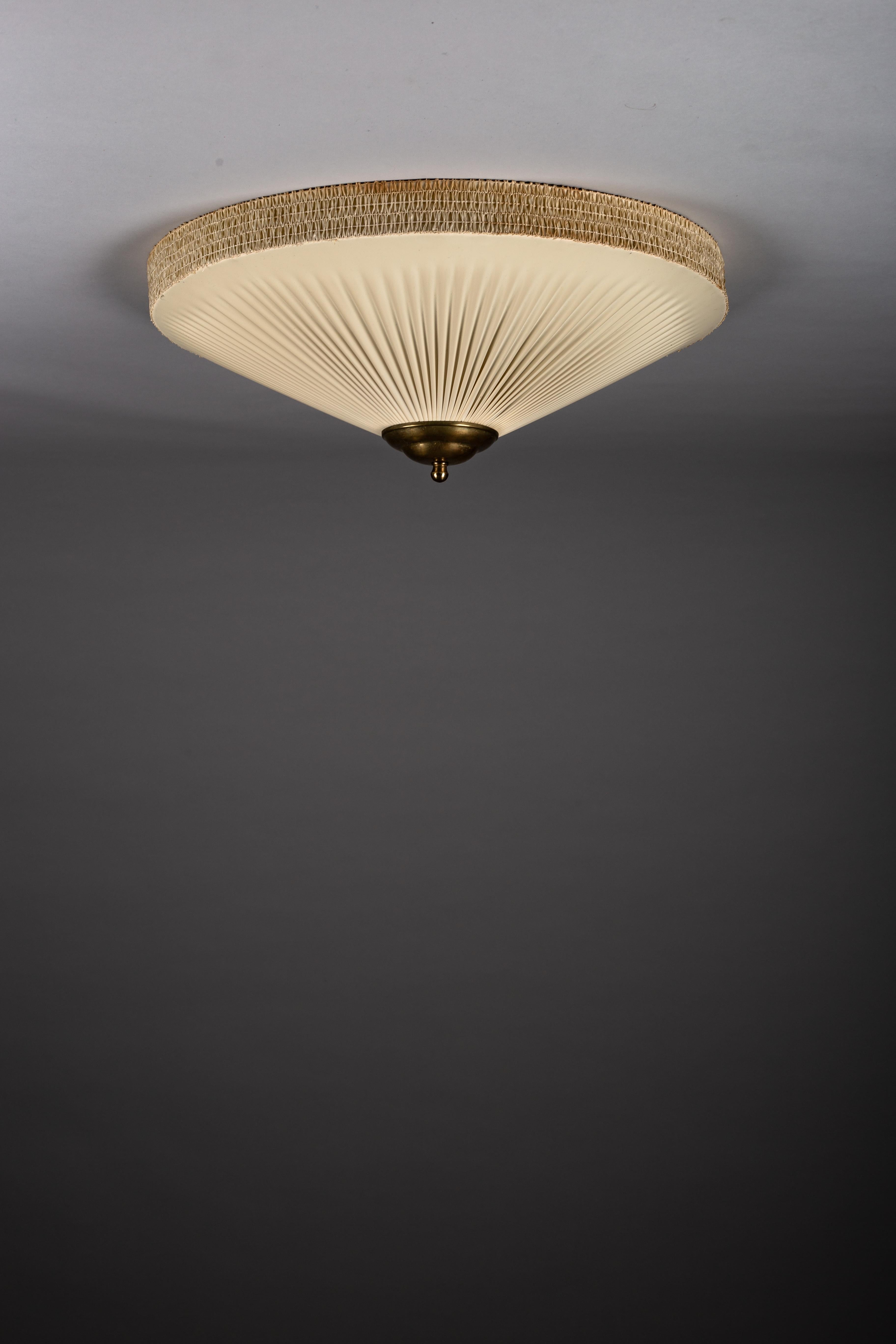 Illuminate your home with the distinguished allure of the 1950's Finnish plafond lamp, measuring 60 cm in diameter. This classic fixture features refined brass details, confirming its vintage provenance. We recognize the value of Scandinavian