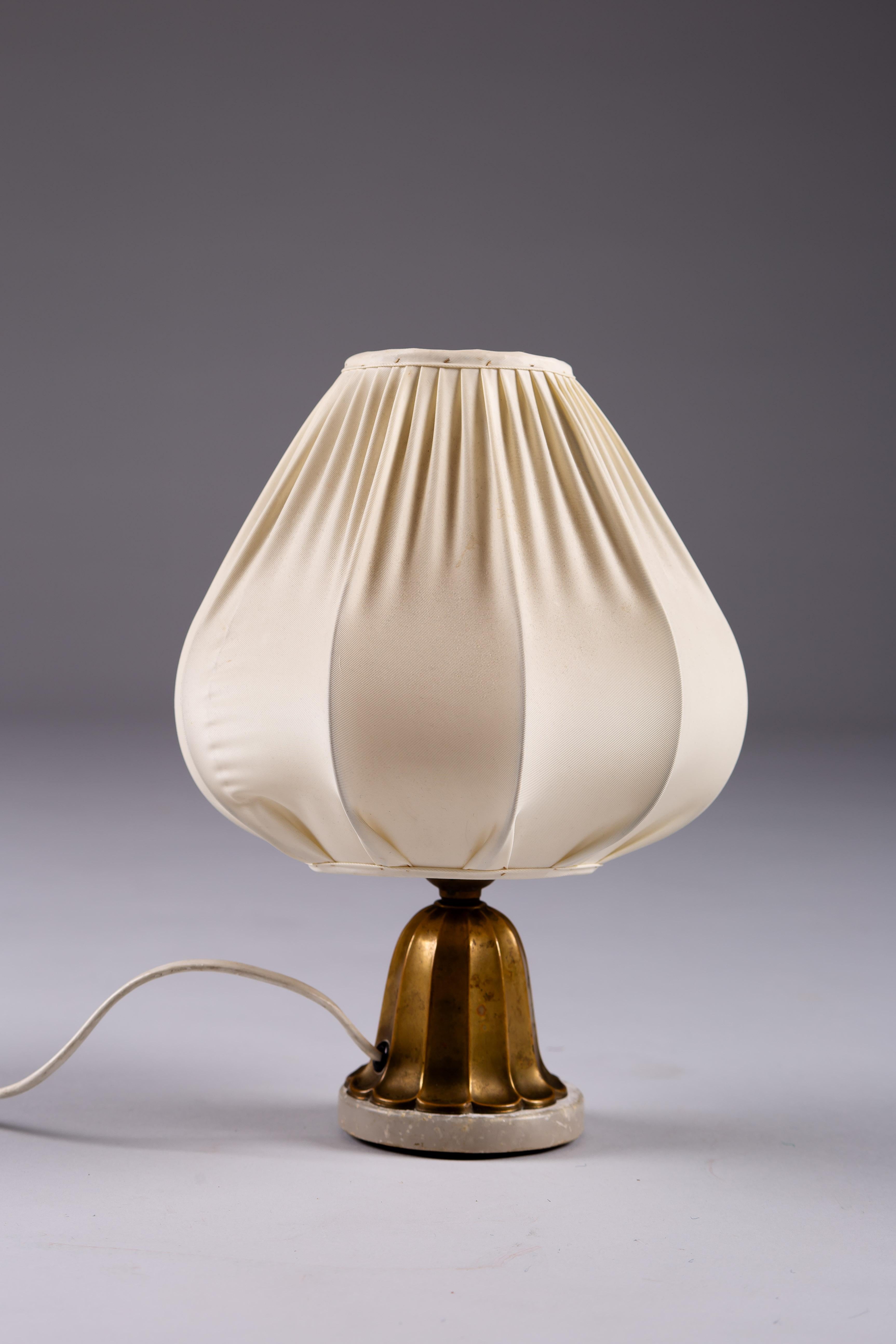 Illuminate your space with a touch of 20th-century elegance with our Finnish Art Deco brass table lamp. This exquisite piece epitomizes Scandinavian vintage design, blending timeless aesthetics with modern functionality. Crafted from high-quality
