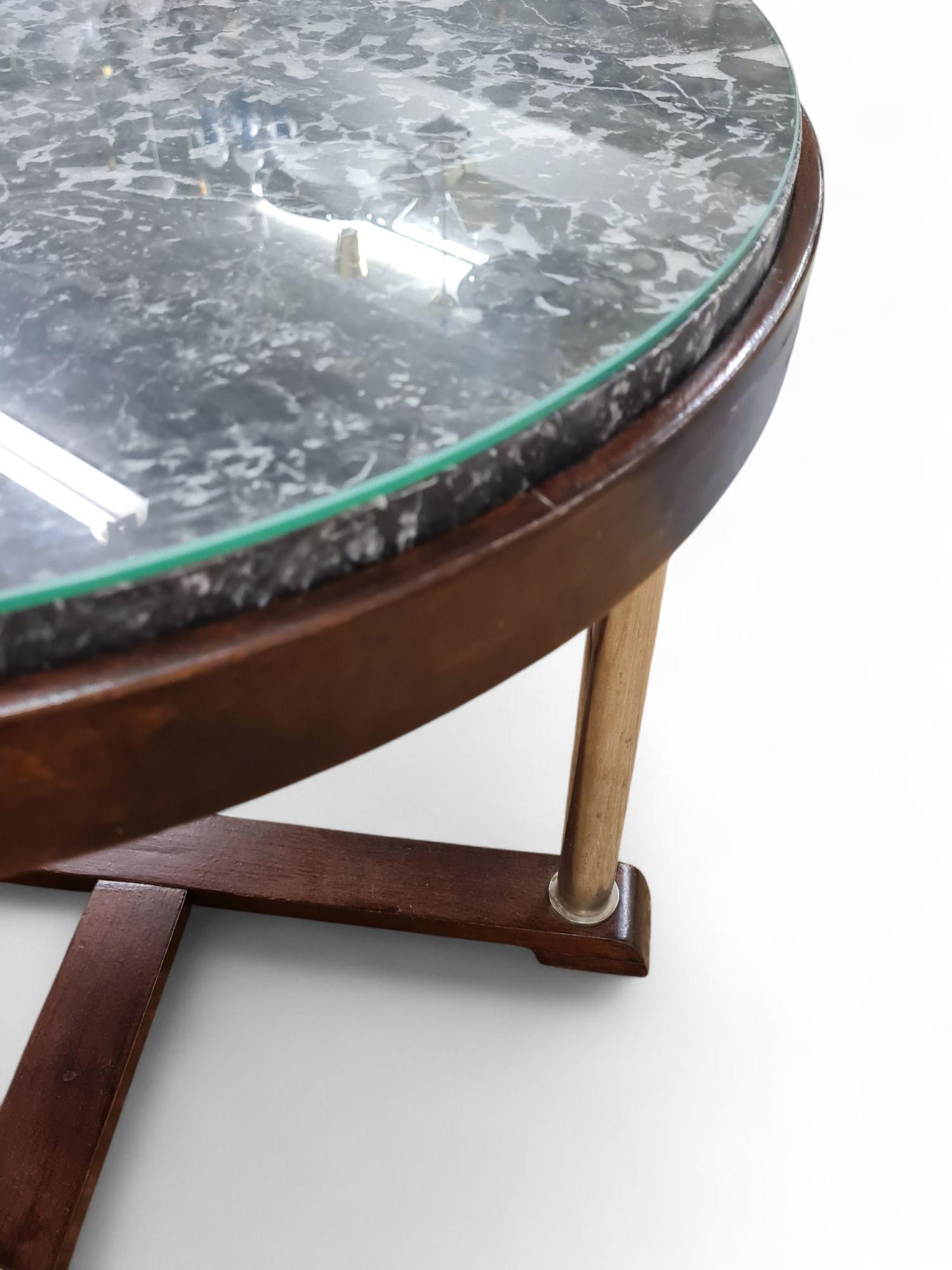 A beautiful Art Deco coffee table featuring an oak base, chrome legs, marble top and a glass cover. The materials used exude an elegance and give it a timeless appeal. It's a perfect blend of vintage charm and sophistication. The item is in great