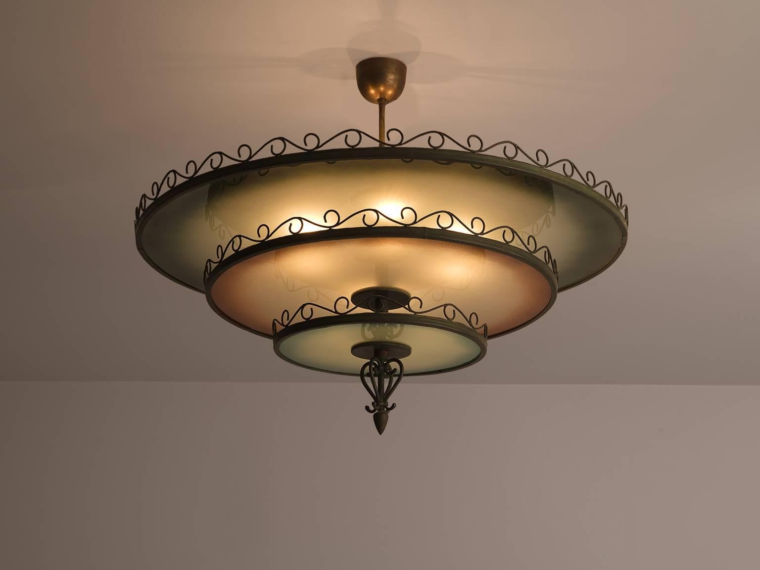 Chandelier glass metal brass, Finland, circa 1930.

This Art Deco chandelier with eloquent forgings and three different shades of glass is both refined and robust at the same time. The chandelier is built up of three different layers in various