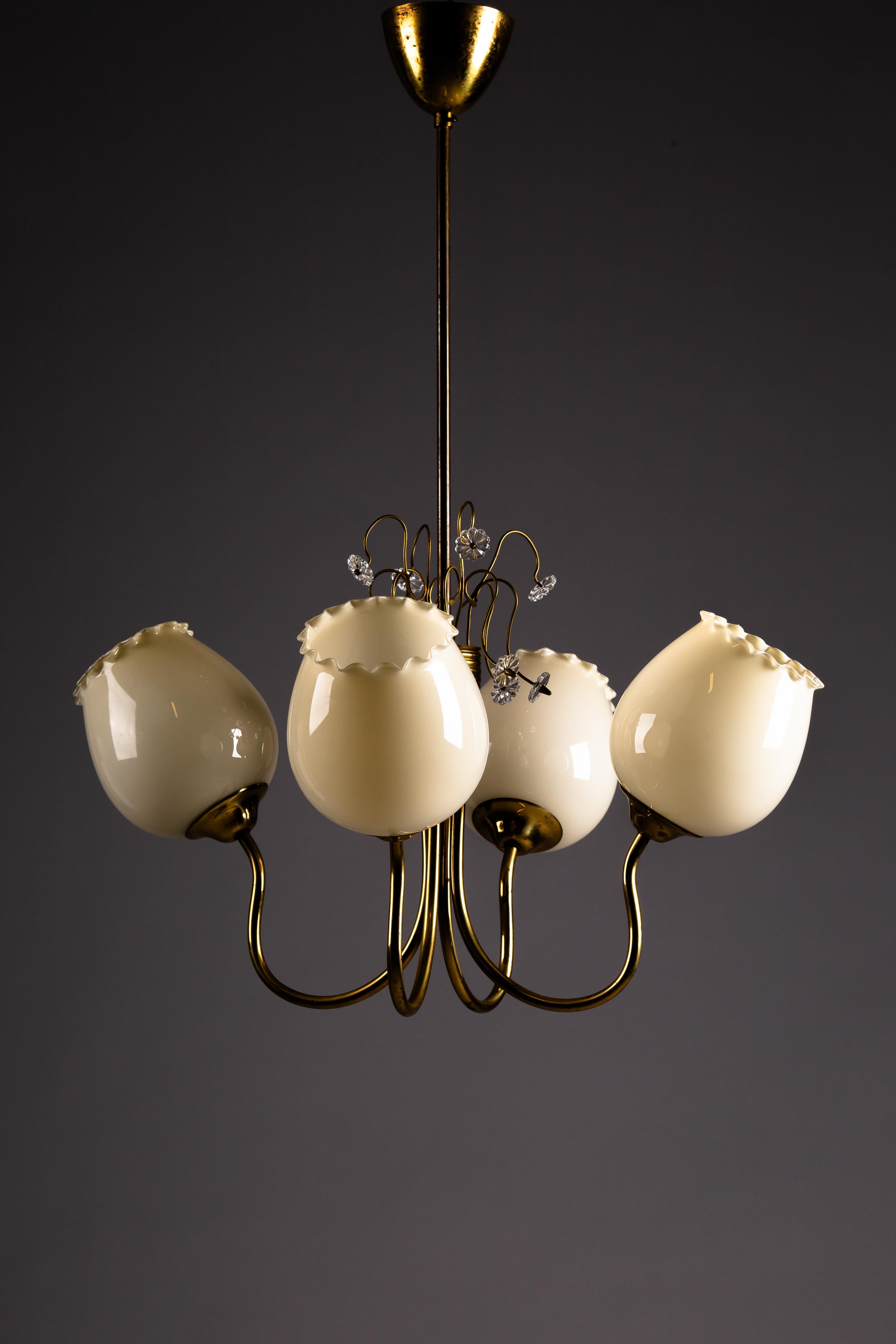 Illuminate your space with timeless elegance using the Finnish brass chandelier by Itsu, a standout from the 1950s. Designed within the heart of Scandinavian Vintage Design, this piece exudes refined craftsmanship and high-quality decor. The