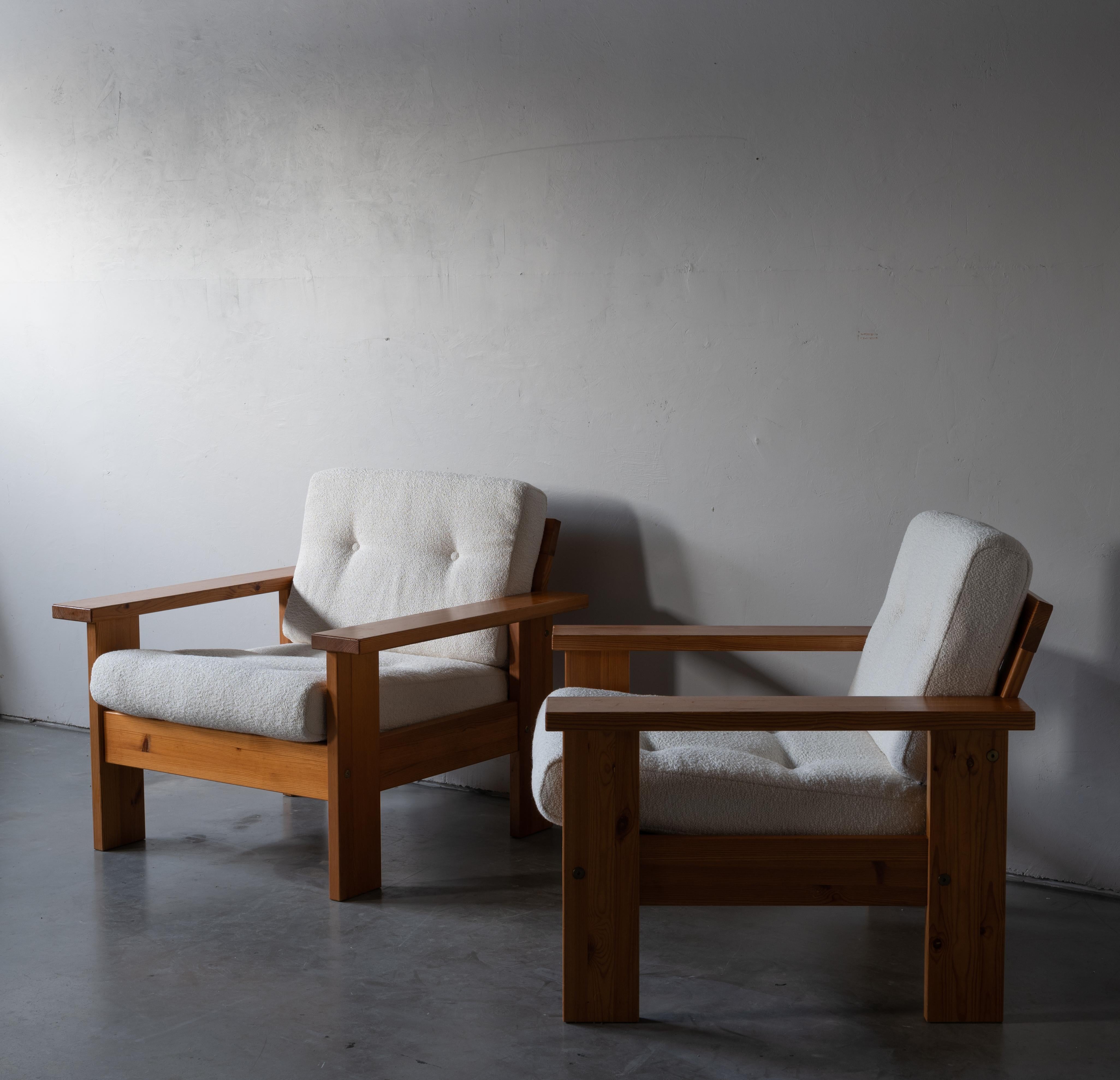 A pair of modernist lounge chair. Designed and made by a Finnish cabinetmaker, 1960s-1970s. In solid pine. Cushions upholstered in brand new high-end bouclé fabric.

Other designers of the period include Axel Einar Hjorth, Pierre Chapo, Charlotte