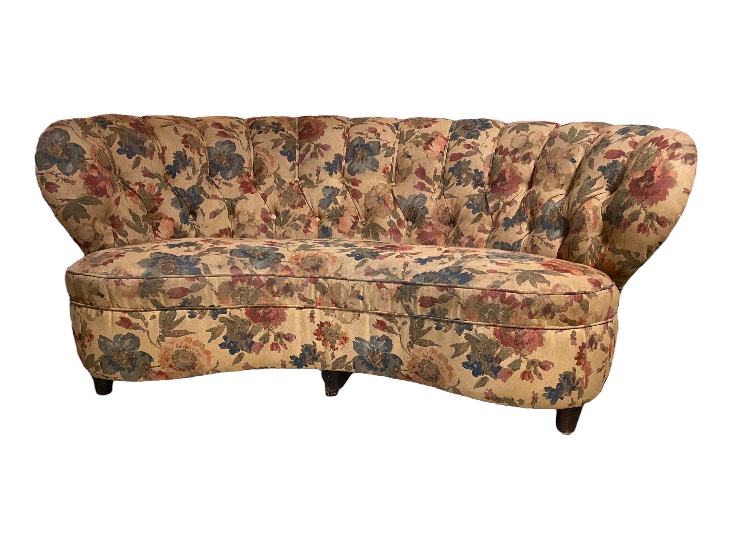 A stand out curved sofa (banana shaped) upholstered with a beautiful flower pattern, and made in Finland in the 1940s. This sofa is attributed to Paul Boman, but due to lack of documentation we won't know for certain. It's a perfect combination of