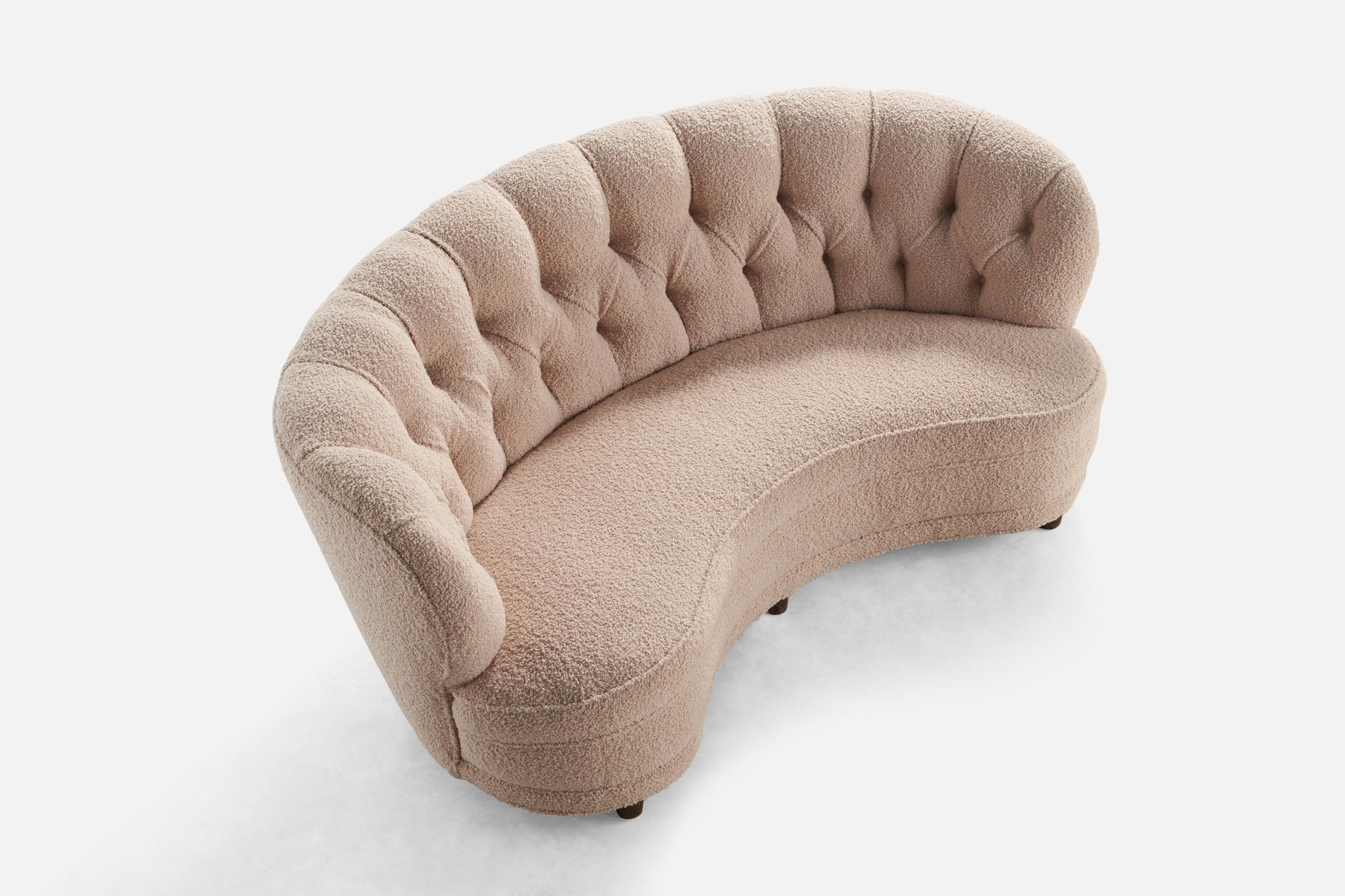 An organic curved dark-stained birch and light pink bouclé fabric sofa designed and produced in Finland, 1940s.

Seat height: 15”