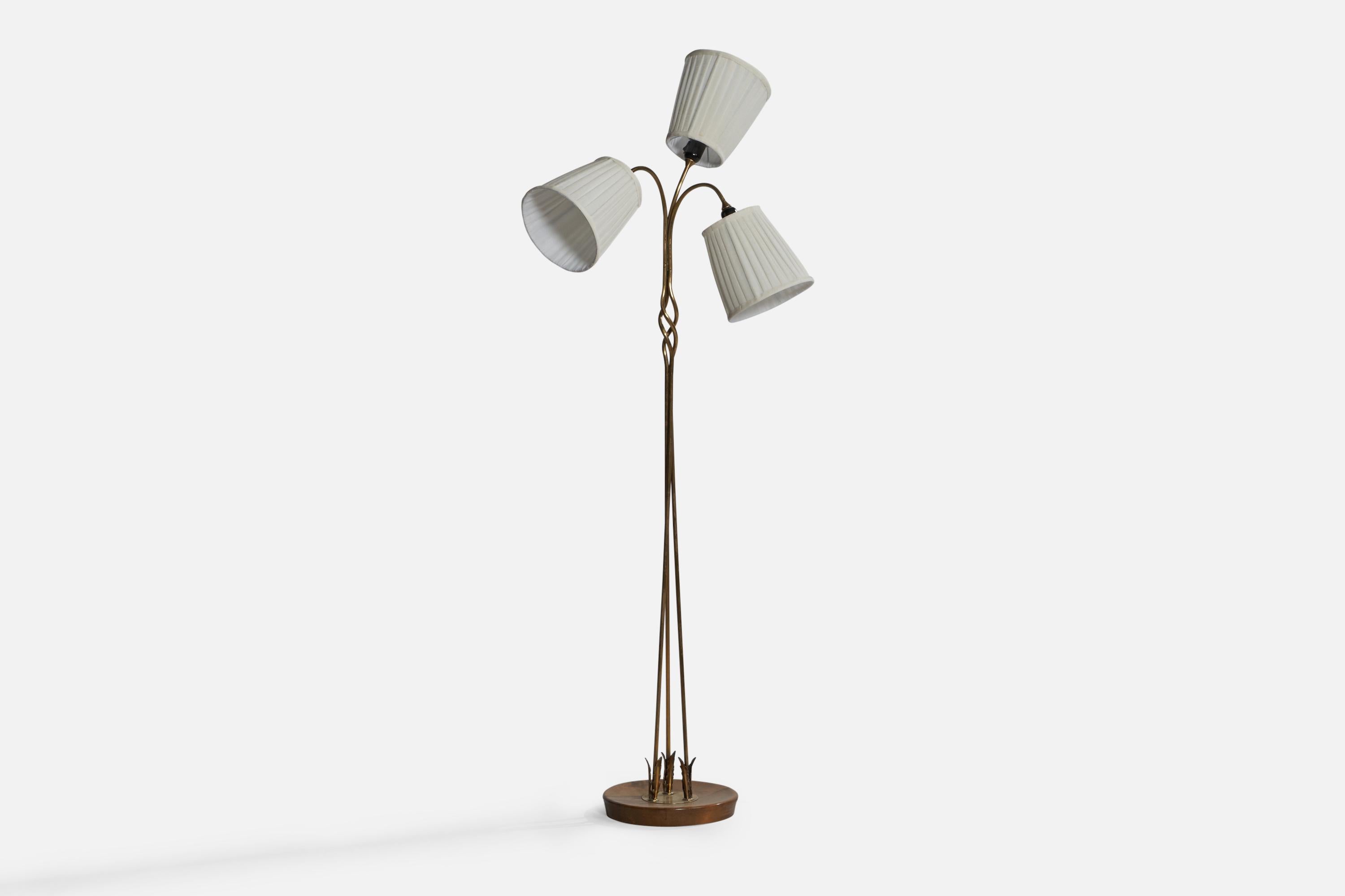A three-armed brass, stained birch and white fabric floor lamp designed and produced in Finland, 1950s.

Overall Dimensions (inches): 66” H x 26” W x 24.75” D. Stated dimensions include shades.
Bulb Specifications: E-26 Bulbs
Number of Sockets: