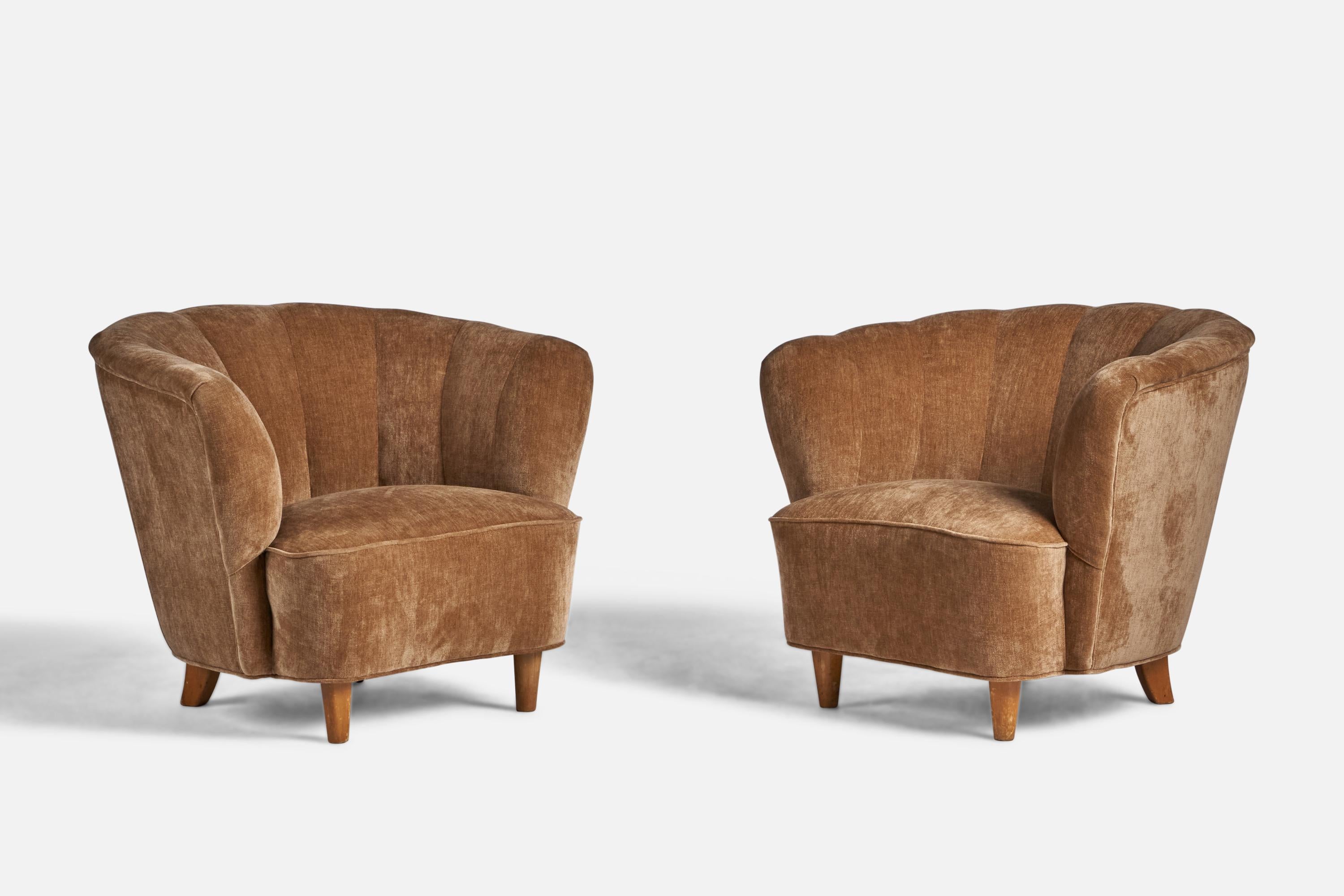 A pair of beige velvet fabric and birch lounge chairs designed and produced in Finland, 1940s.
Seat height: 14.5”
