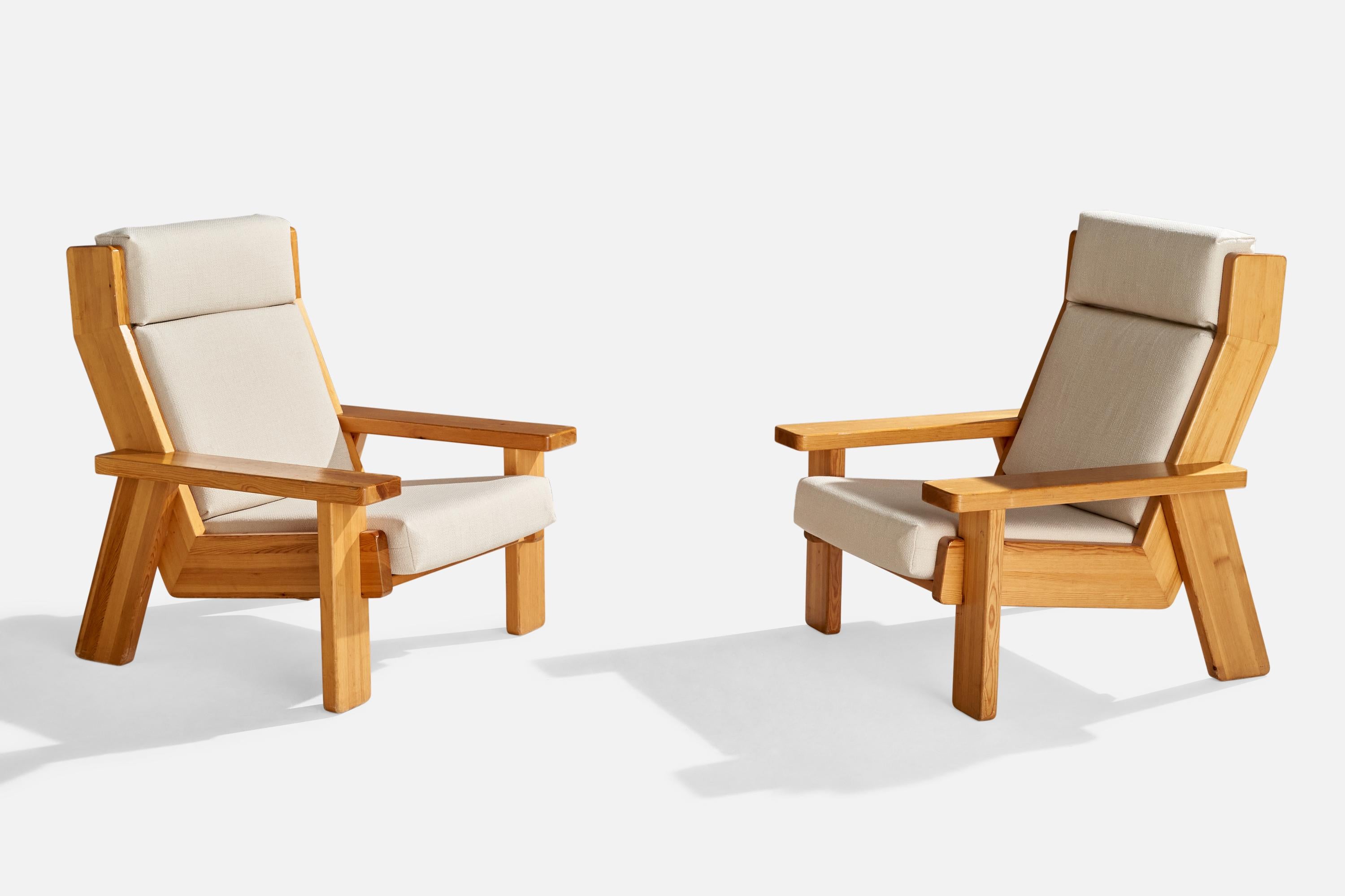 A pair of pine and white fabric lounge chairs designed and produced in Finland, c. 1970s.

Seat height: 15.75

Reupholstered in a brand new fabric.

All upholstered furniture can be reupholstered upon request for an additional fee. Lead times will