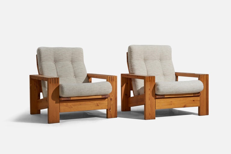 A pair of pine and fabric lounge chairs designed and produced in Finland, 1970s. 

