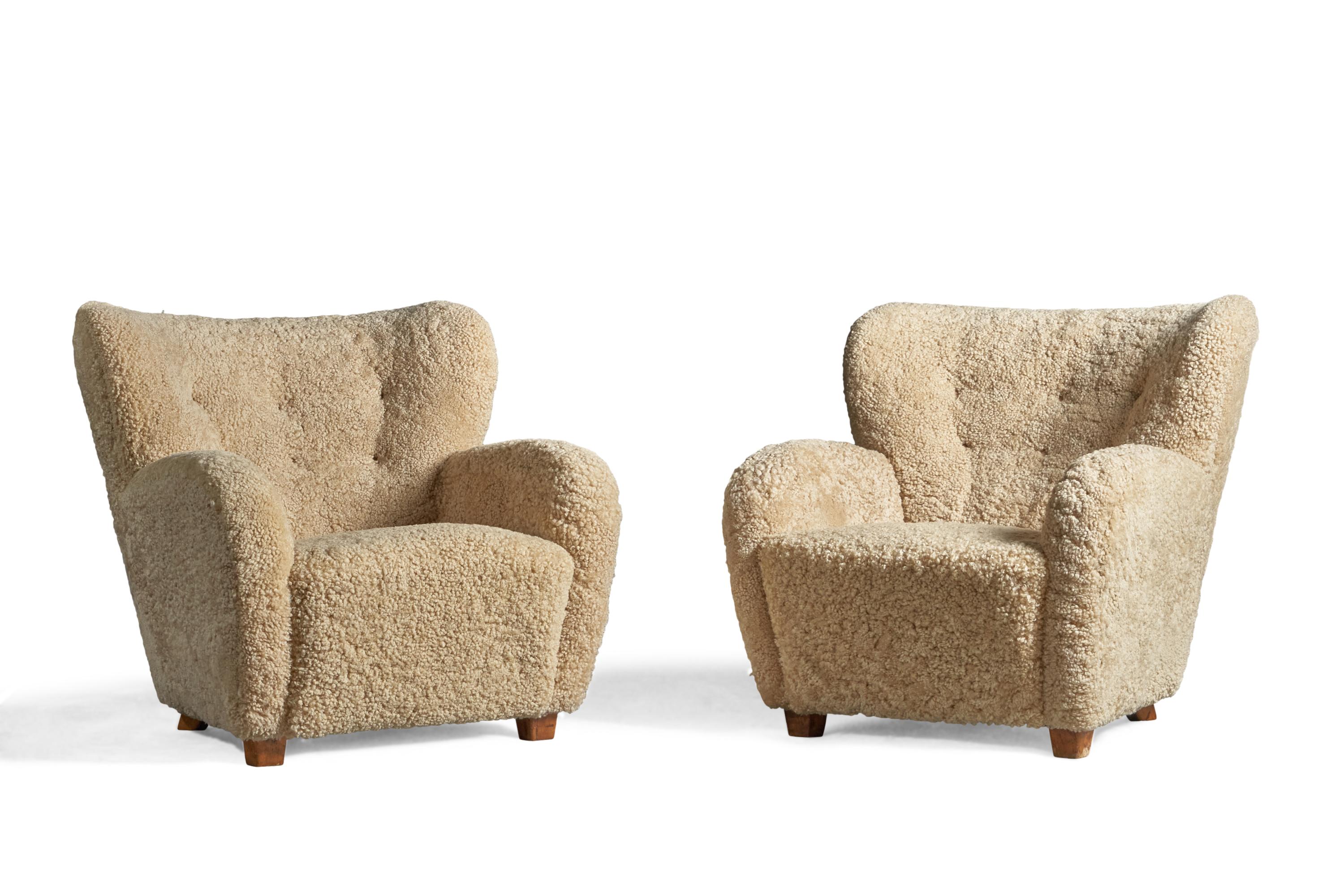 A pair of shearling and birch lounge chairs, designed and produced in Finland, 1940s.

15