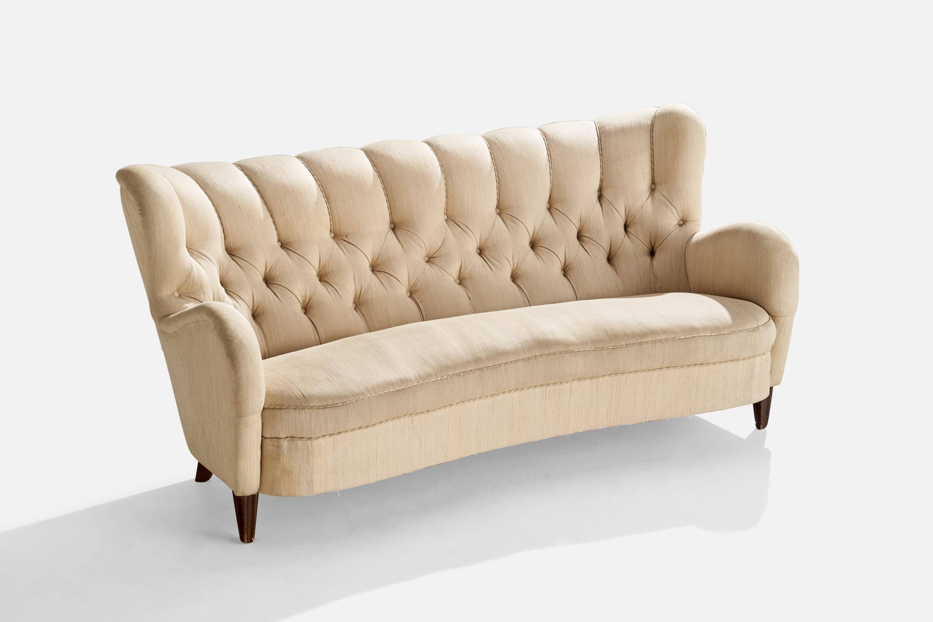 A dark-stained wood and beige fabric sofa designed and produced in Finland, c. 1940s.

Seat height 17”.