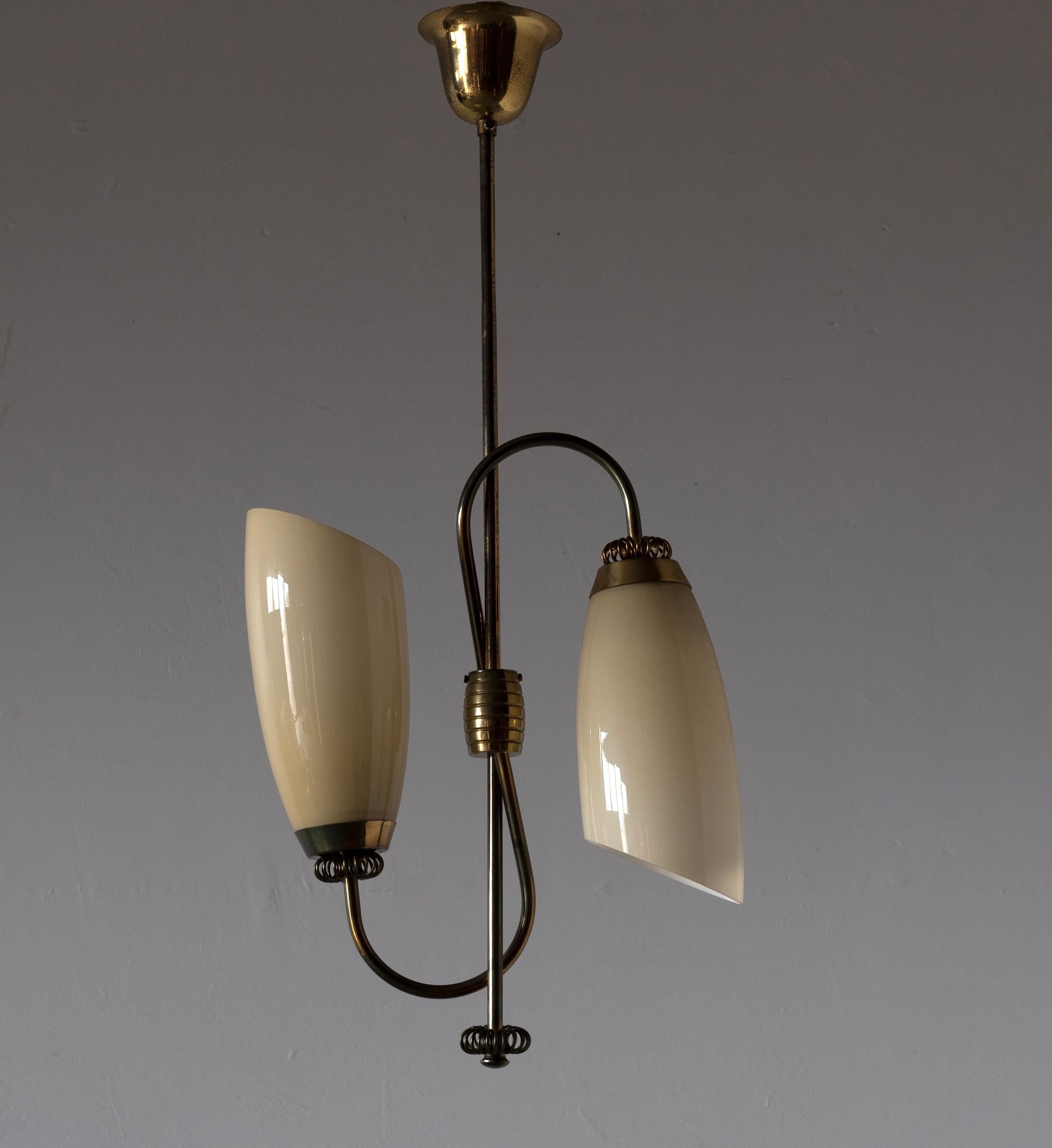 A two-armed pendant / chandelier light, designed and produced in Finland, 1940s. Features milk glass and brass.

Other designers of the period include Paavo Tynell, Alvar Aalto, Lisa Johansson-Pape, J.T. Kalmar, and Josef Frank.