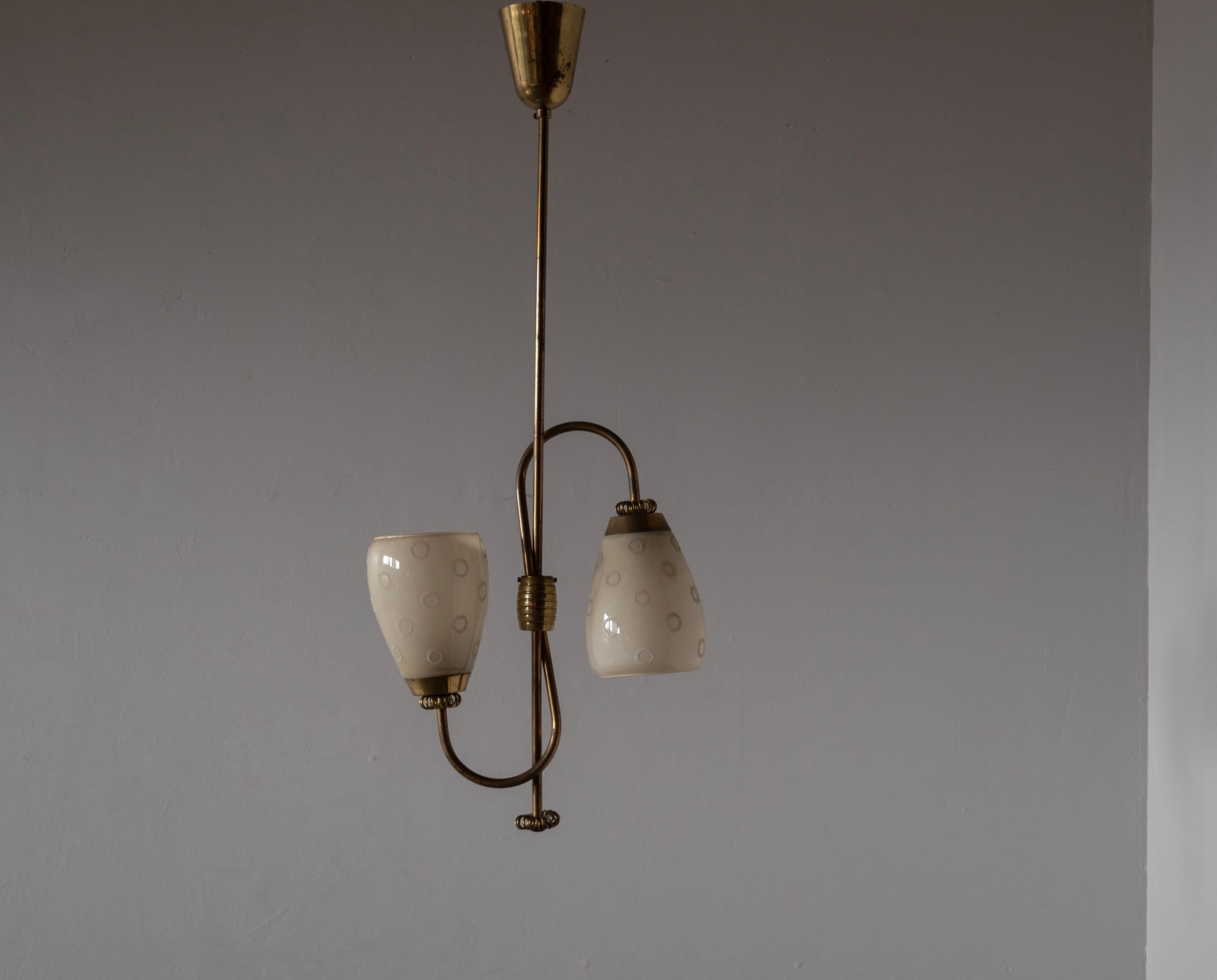 A two-armed pendant / chandelier light, designed and produced in Finland, 1940s. Features milk glass with subtle ornamentation and brass.

Other designers of the period include Paavo Tynell, Alvar Aalto, Lisa Johansson-Pape, J.T. Kalmar, and Josef