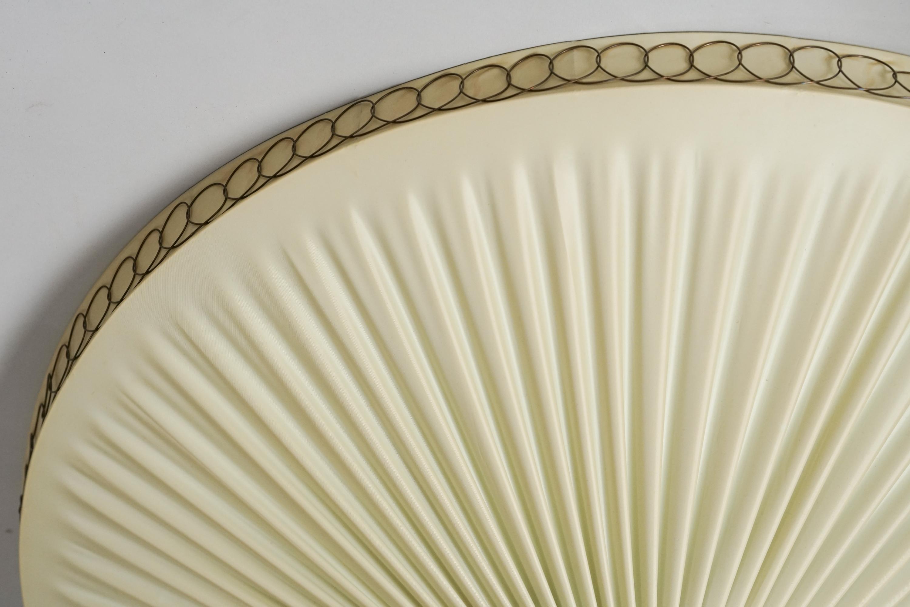 Finnish flush mount from the 1950/1960s. Plastic lampshade with brass details. Good vintage condition, patina consistent with age and use. Beautiful Scandinavian Modern design suitable for many different types of spaces. 