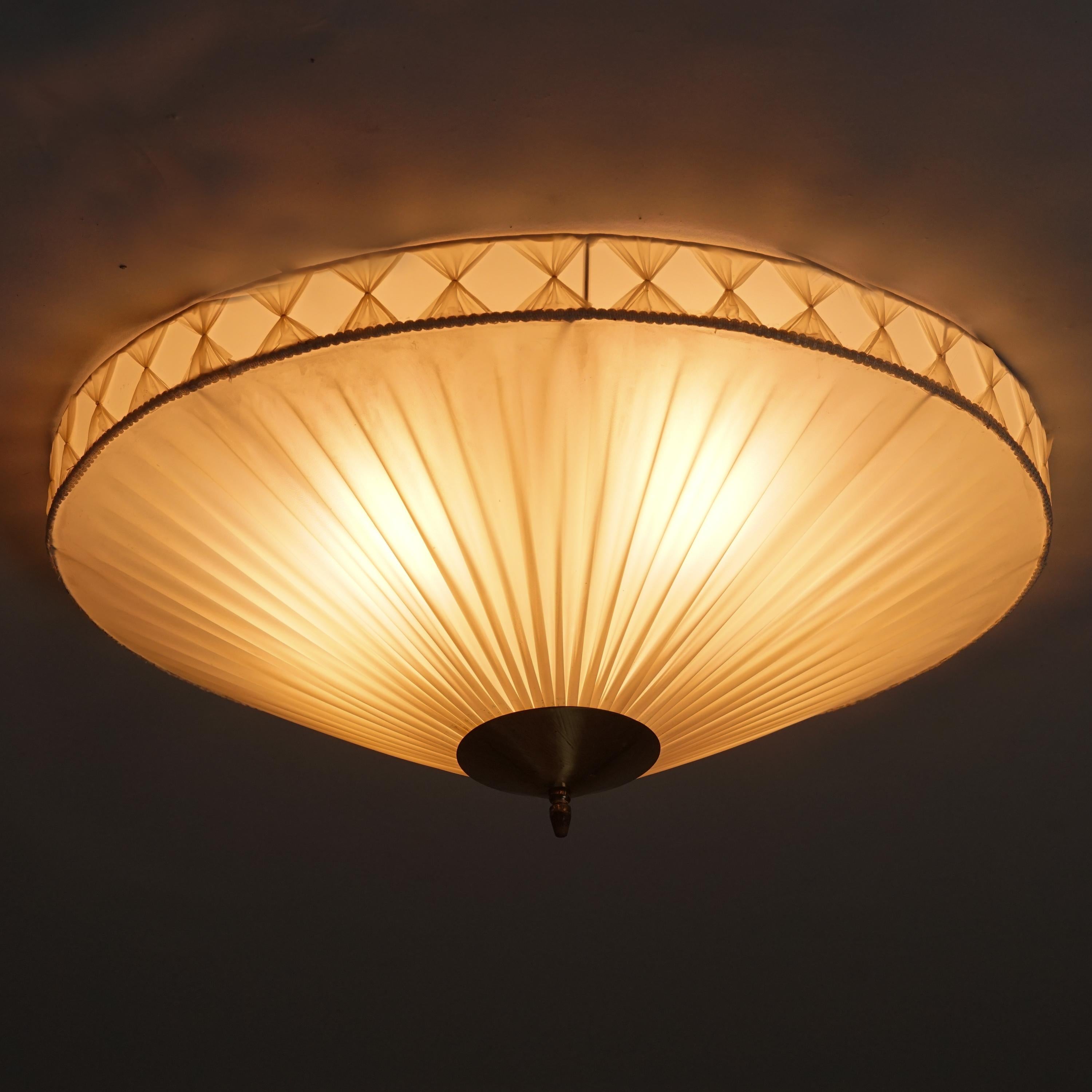 Finnish flush mount, 1950/1960s. Plastic shade with beautiful details on the side. Brass details, metal frame. Good vintage condition, minor patina consistent with age and use. 