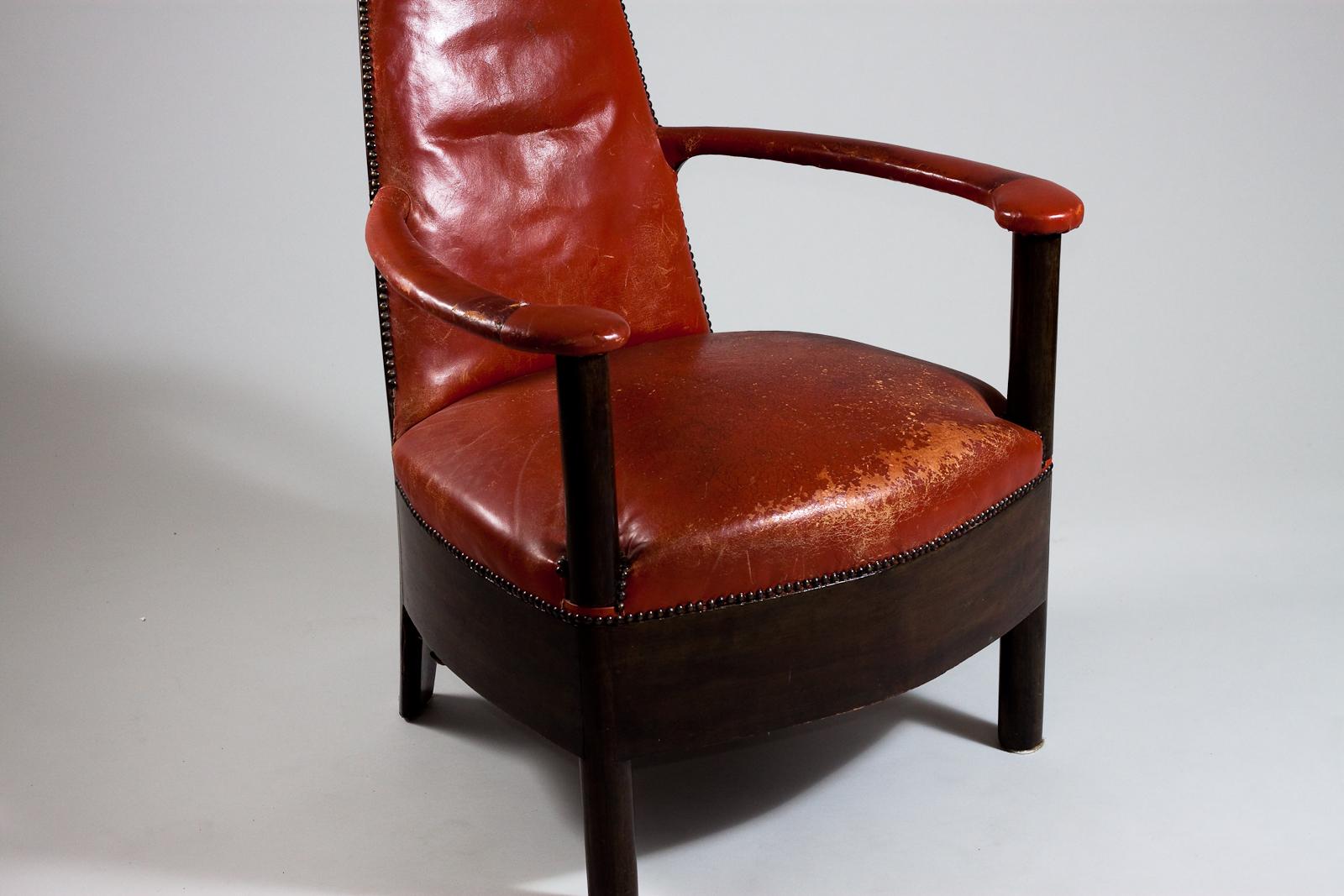 This one-of-a-kind Finnish jugend tall armchair is a timeless piece of furniture, boasting beautiful craftsmanship and an impressive design. Upholstered in luxurious red leather, it is sure to make a statement in any room. The tall back and armrests