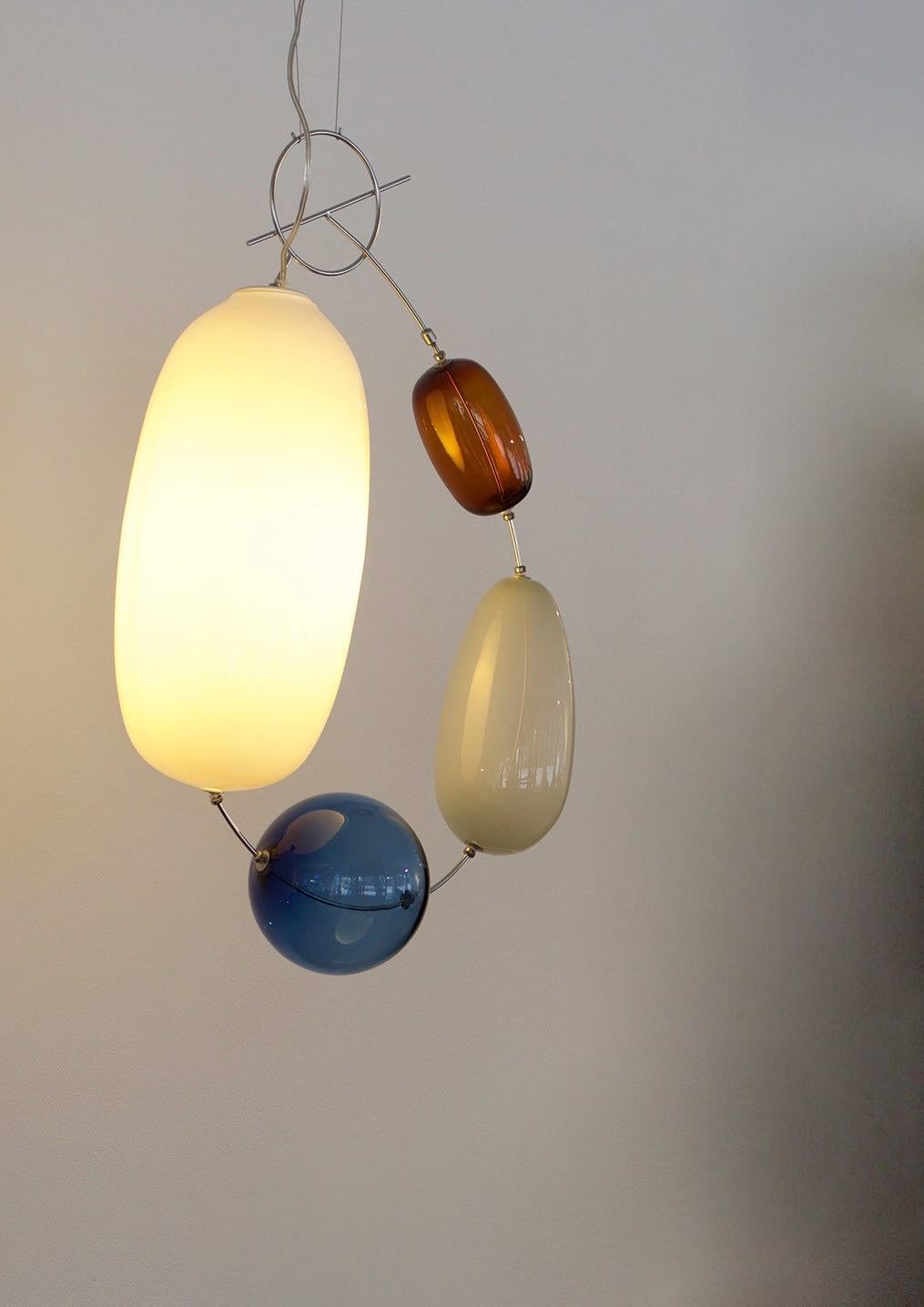 Exceptional pendant made out of mouth blown glass and stainless steel. A quality contemporary design named 'Hely' by Finnish designer Katriina Nuutinen.
The design was originally designed in 2009 and is made in a limited edition of only 200 pieces
