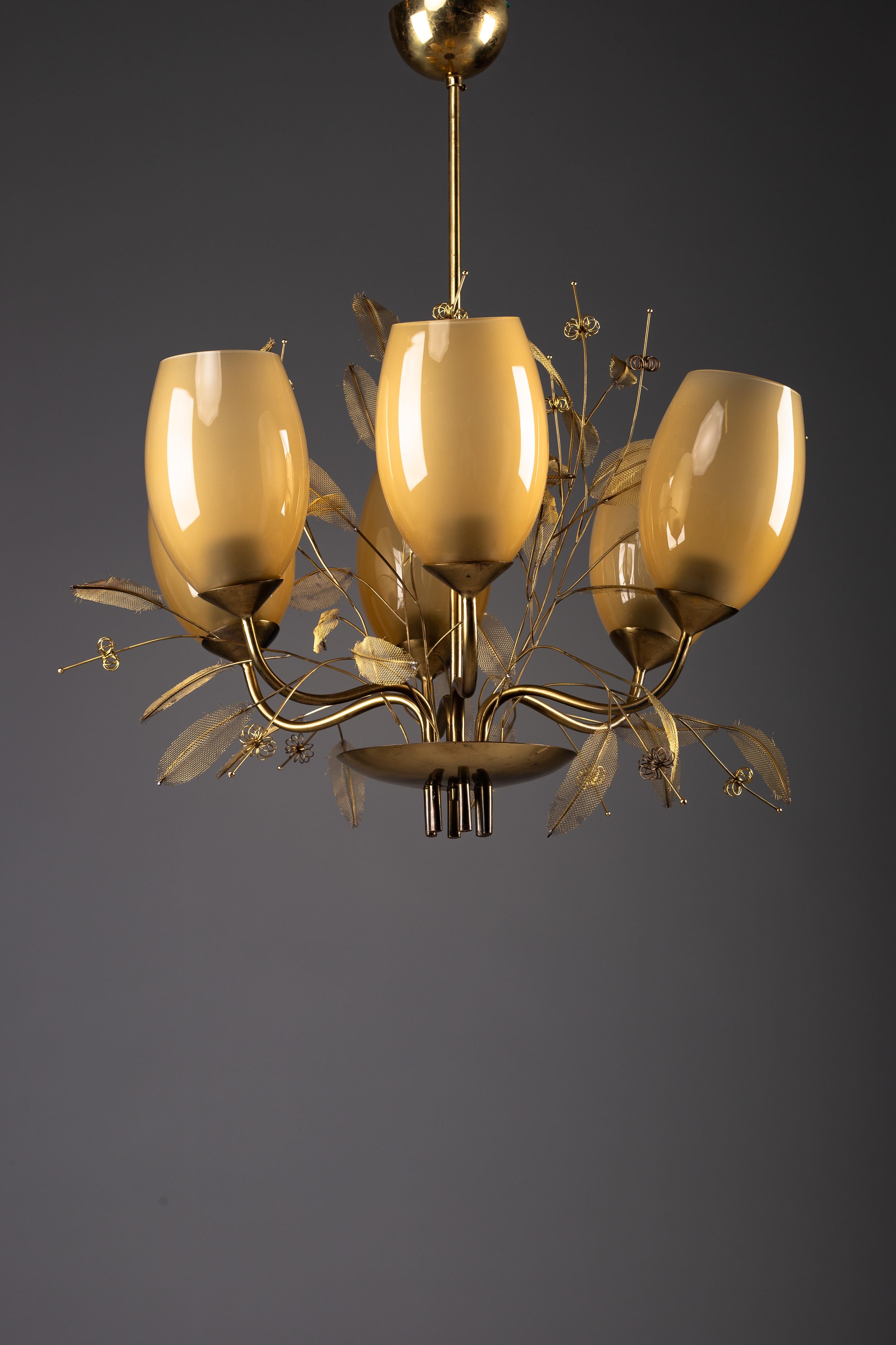 Eleva tu espacio con esta elegante araña decorativa de latón, inspirada en la belleza atemporal de un ramo de novia y atribuida al renombrado diseñador finlandés Paavo Tynell. Esta impresionante pieza, disponible en Nordisten, encarna la esencia del