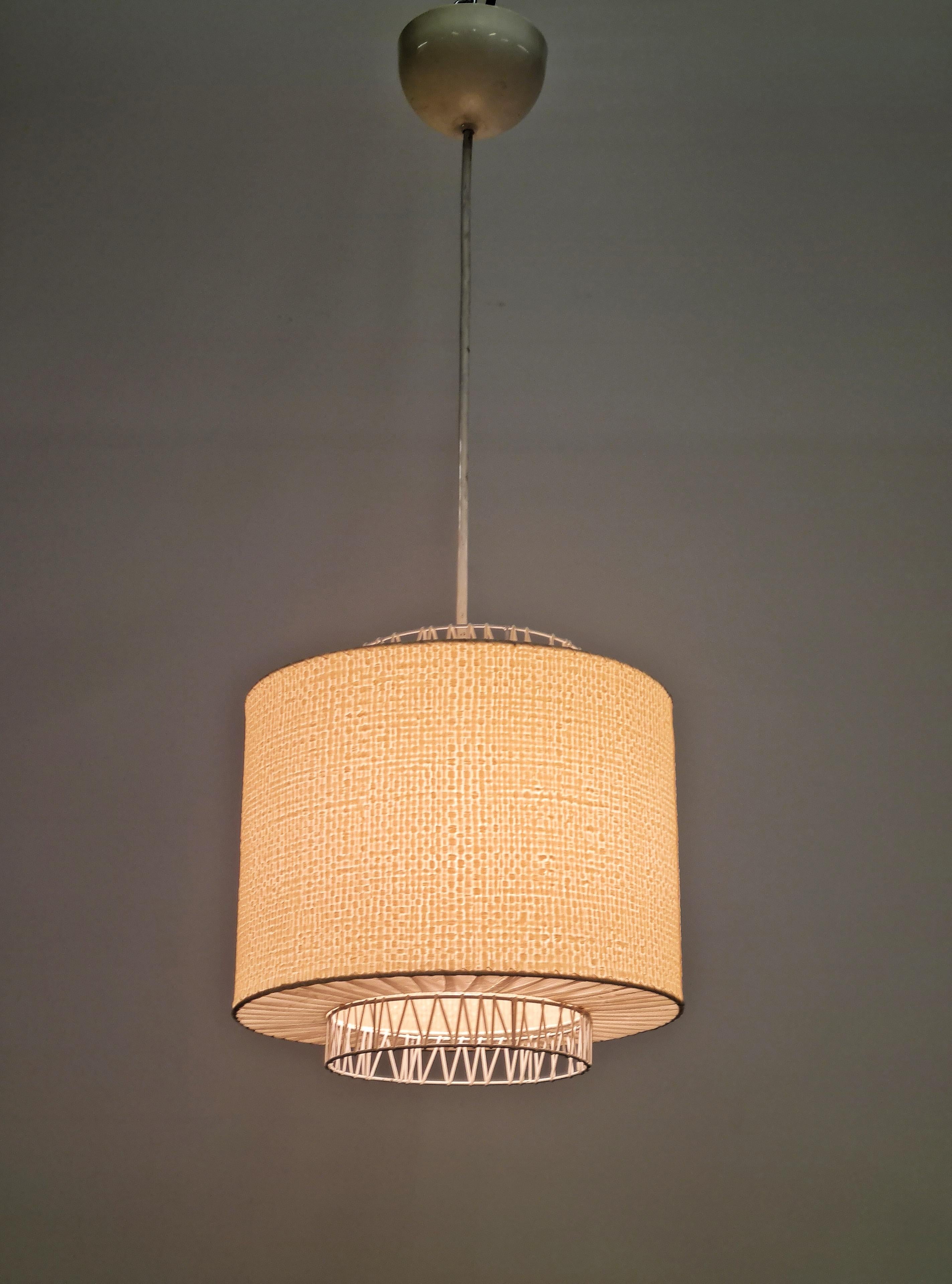A stunningly beautiful ceiling pendant lamp made of a metal frame with a plastic  and paper wrap shade. The lamp is in its beautiful original condition.
A really pleasant design that we have not come across before and cannot identify the designer.