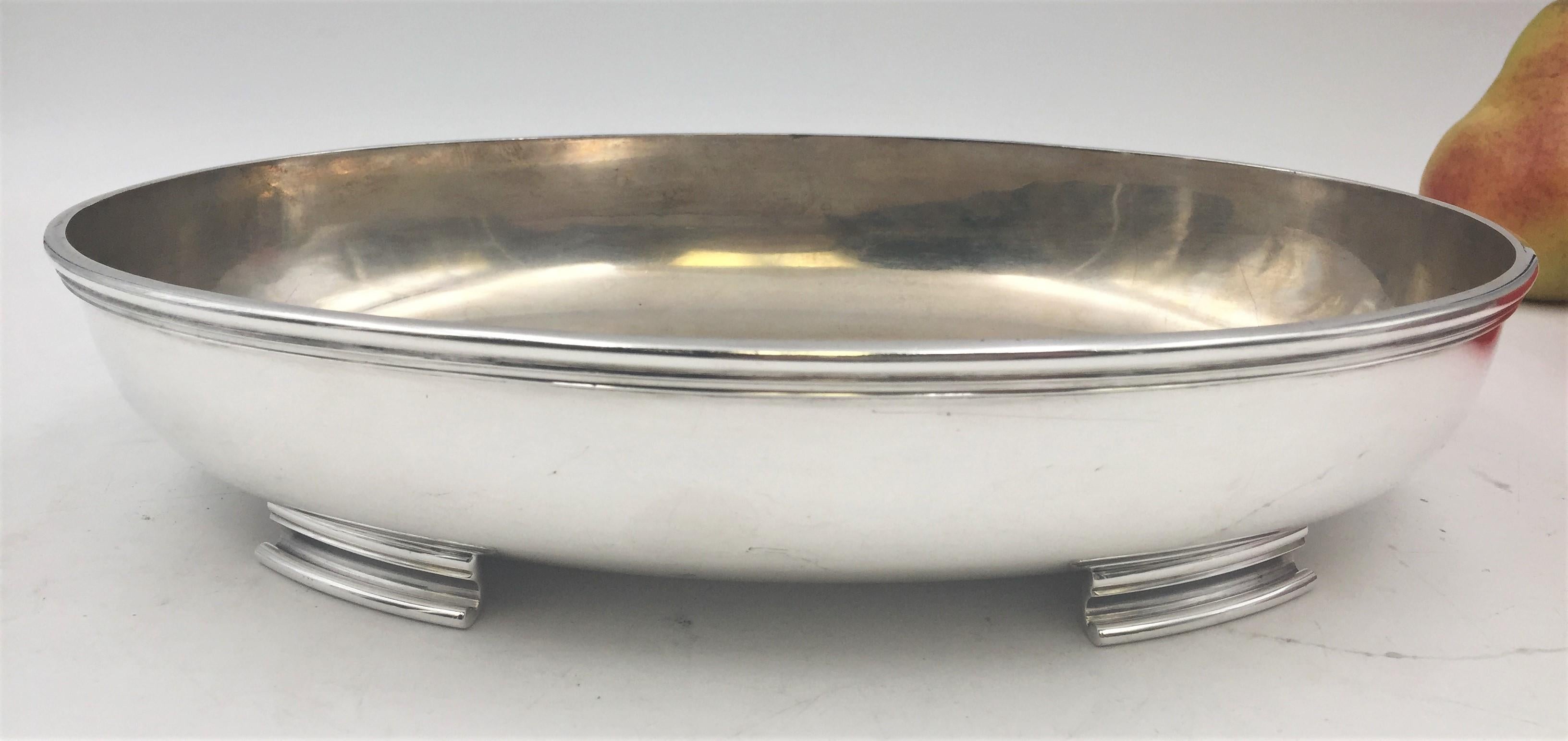 1942 Finnish silver centerpiece bowl in Mid-Century Modern style standing on 4 feet in a beautiful, curvilinear design and with faintly gilt interior. It measures 11 1/3'' in length by 7 7/8'' in width by 2 1/2'' in height, weighs 24.1 ozt, and