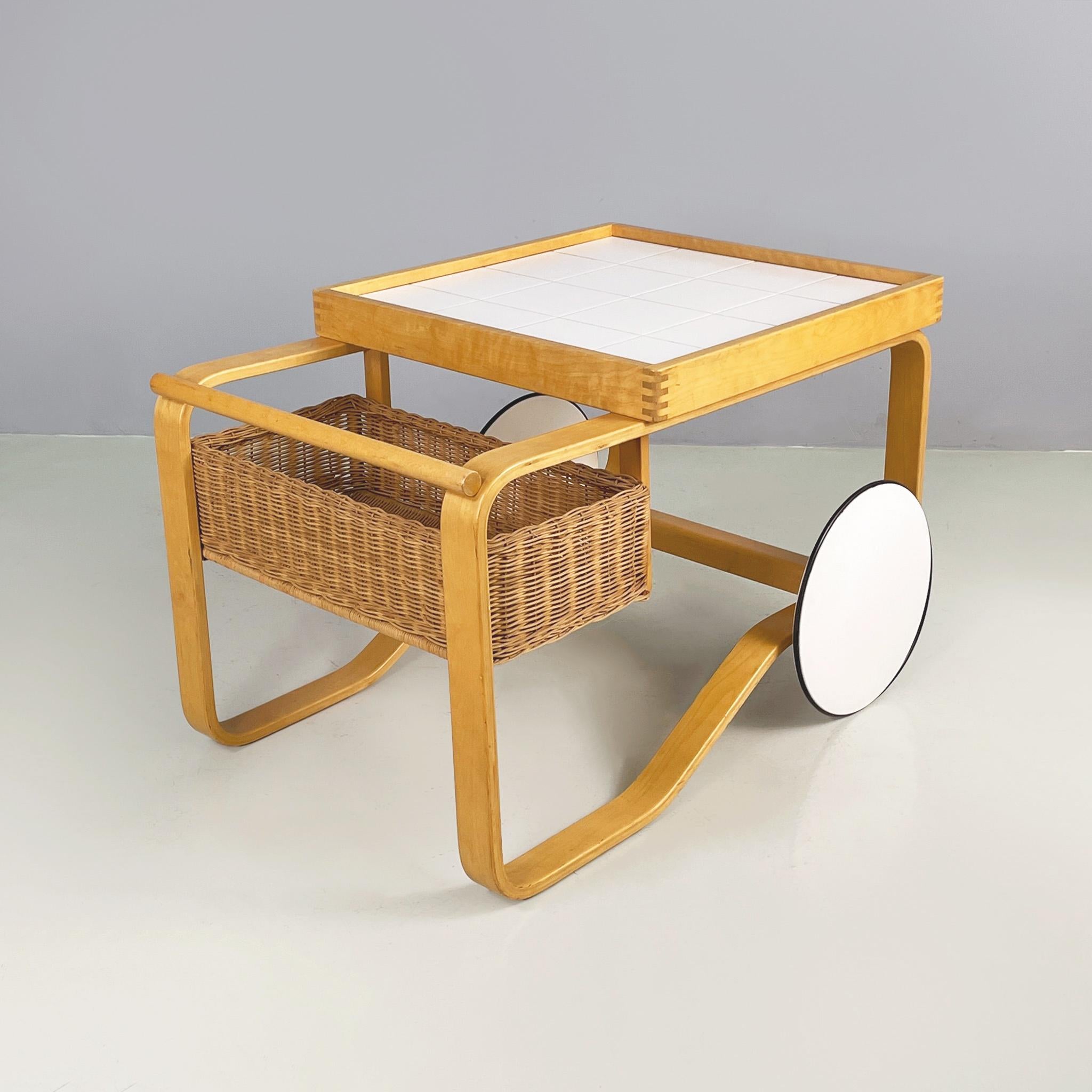Finnish modern wood, wicker Cart Tea Trolley 900 by Alvar AAlto for Artek, 1970s
Cart mod. Tea Trolley 900 in light wood, wicker and white ceramic. The rectangular top features square white ceramic tiles and a raised wooden profile. On one side