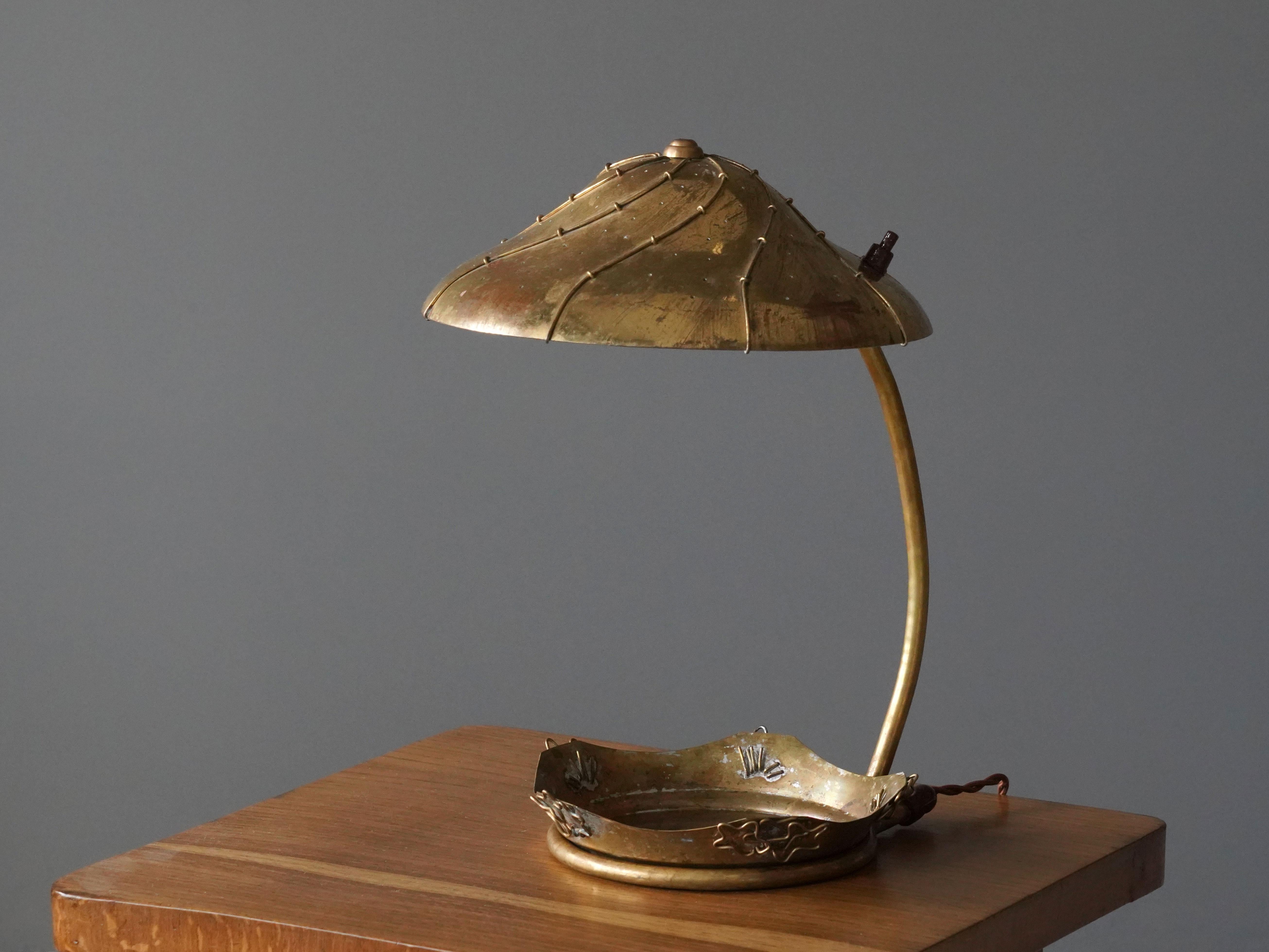 A modernist and organic table lamp. Designed by an unknown Finnish designer. The small tray is removable and can be flipped upside down and placed beneath the lamp as a riser. 

Other Finnish designers of the era include Paavo Tynell, Lisa