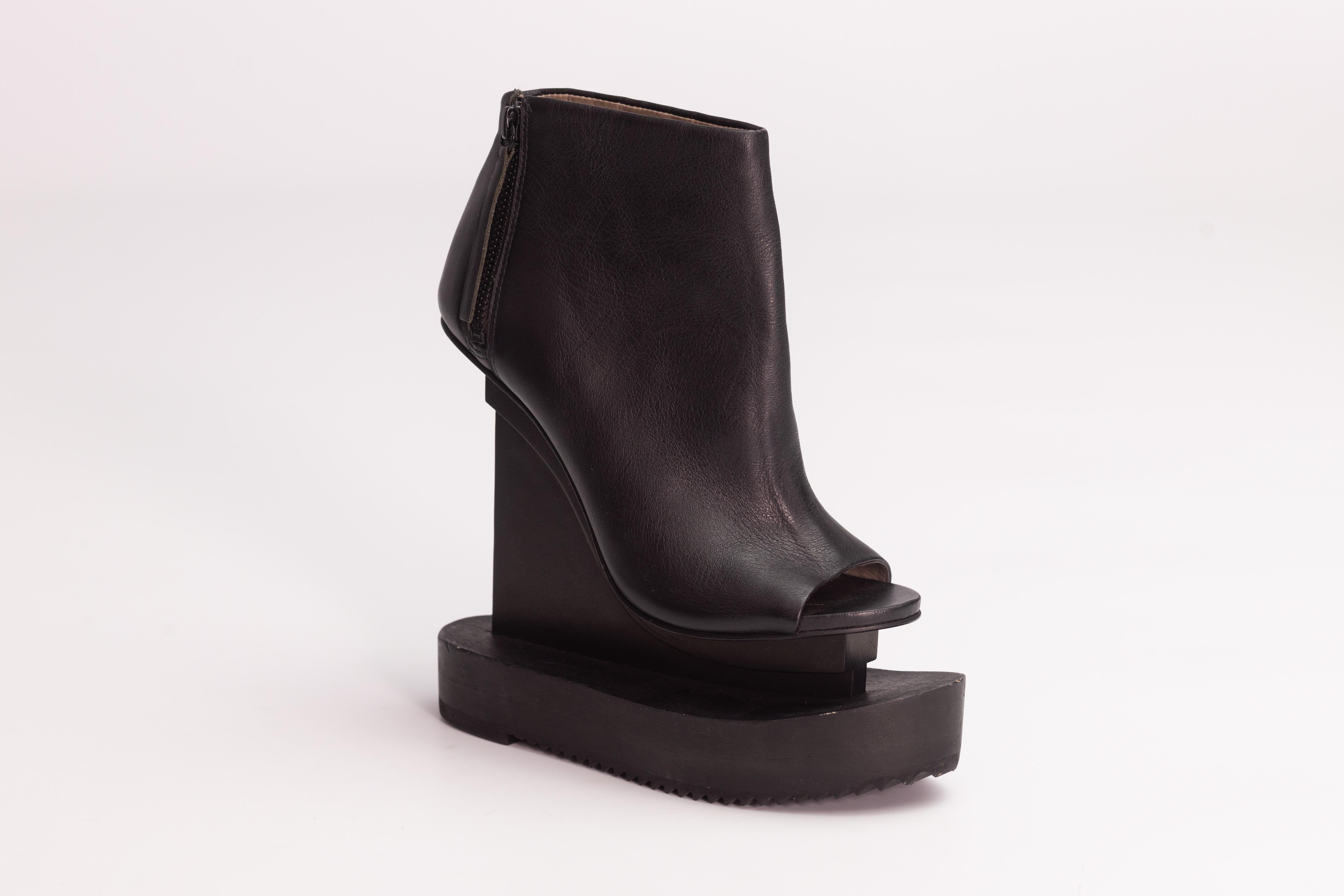 Color: Black
Material: Wood construction
Size: 37 EU / 6 US
Heel Height: 150 mm / 6”
Bottom Platform Height: 31 mm / 1.25” 
Top Platform Height: 25 mm / 1” 
Condition: Very good. Faint hairline marks to leather. Pristine.
Comes with: No brand dust