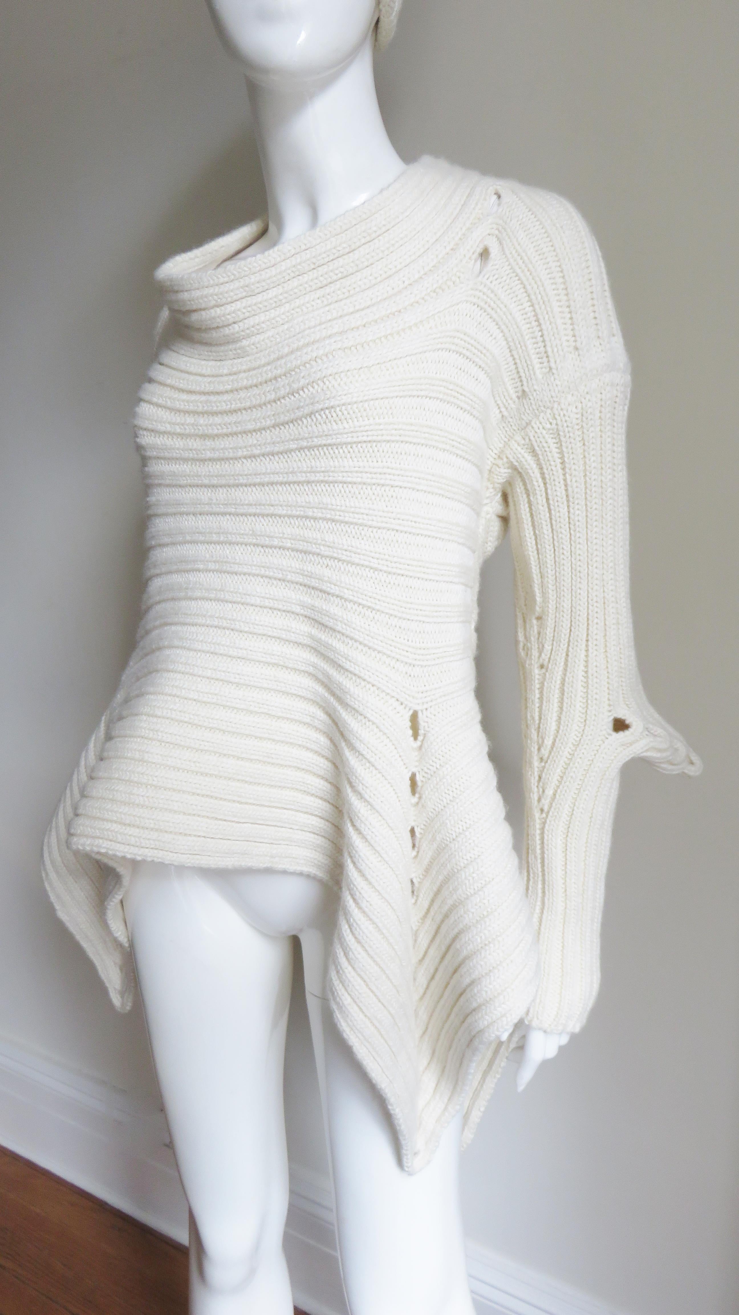 A fabulous off white wool Irish hand knit sweater and hat by Fintan Mulholland.  It is unique with a pointed hem and elbows with rows of holes along each and across the upper back.  It comes with a matching hat.
Fits sizes Small, Medium,