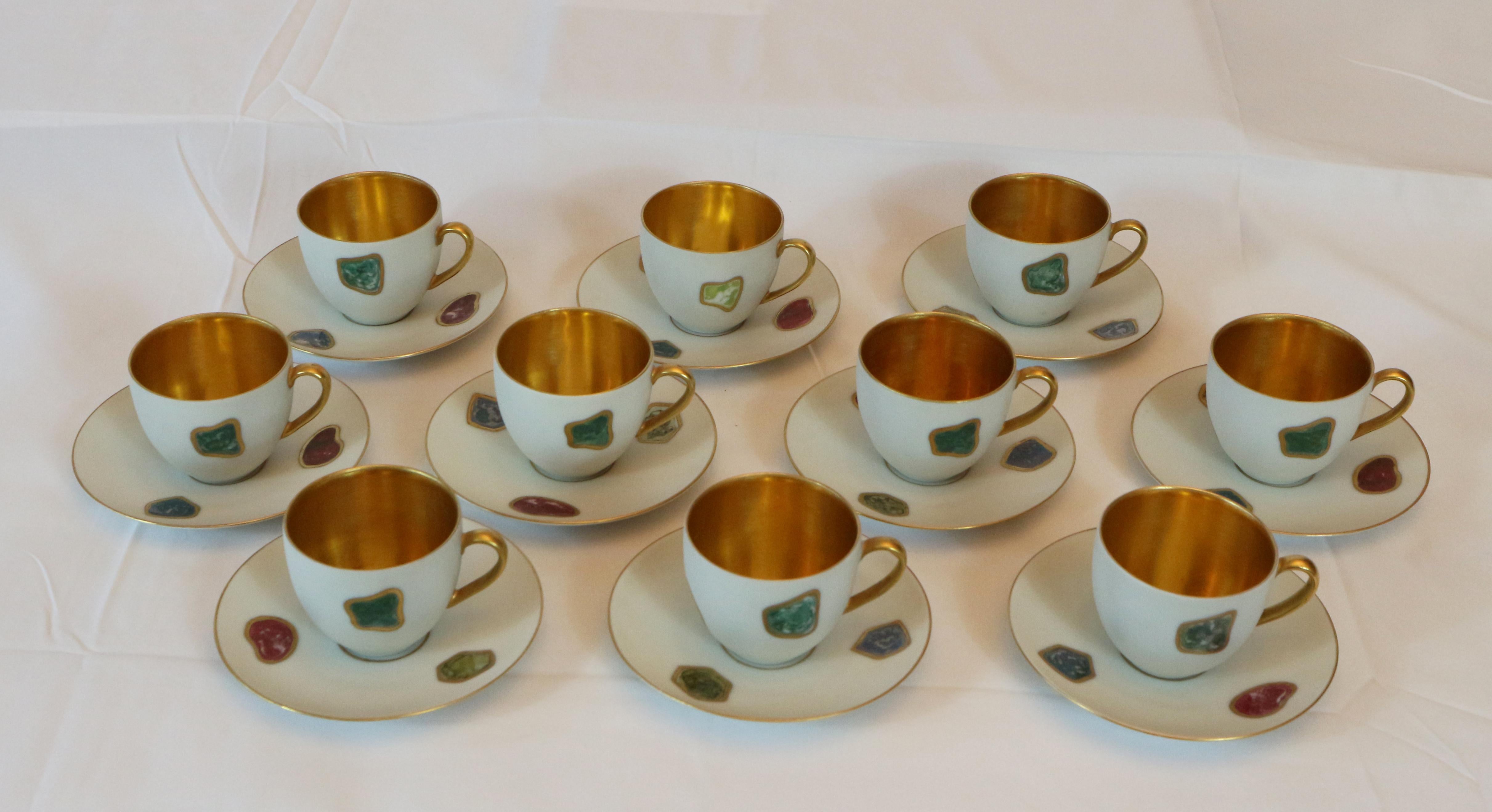Arrigo Finzi set of 10 porcelain coffee cups painted and gilded .The cups and saucers are entirely painted on a white background with inserts edged in 24-karat gold with beautiful colors in imitation of marble. Internal 24-karat gold.