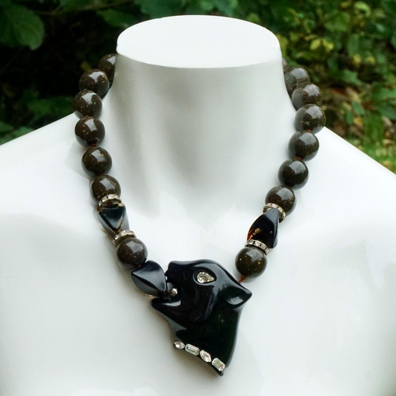 Fabulous Fiocchi Italy black panther and brown resin bead necklace. The resin panther is set with clear rhinestones. The round beads are flecked and knotted between each bead. There are four rhinestone rondelles. Length 47.8 cm / 18.8 inches. The